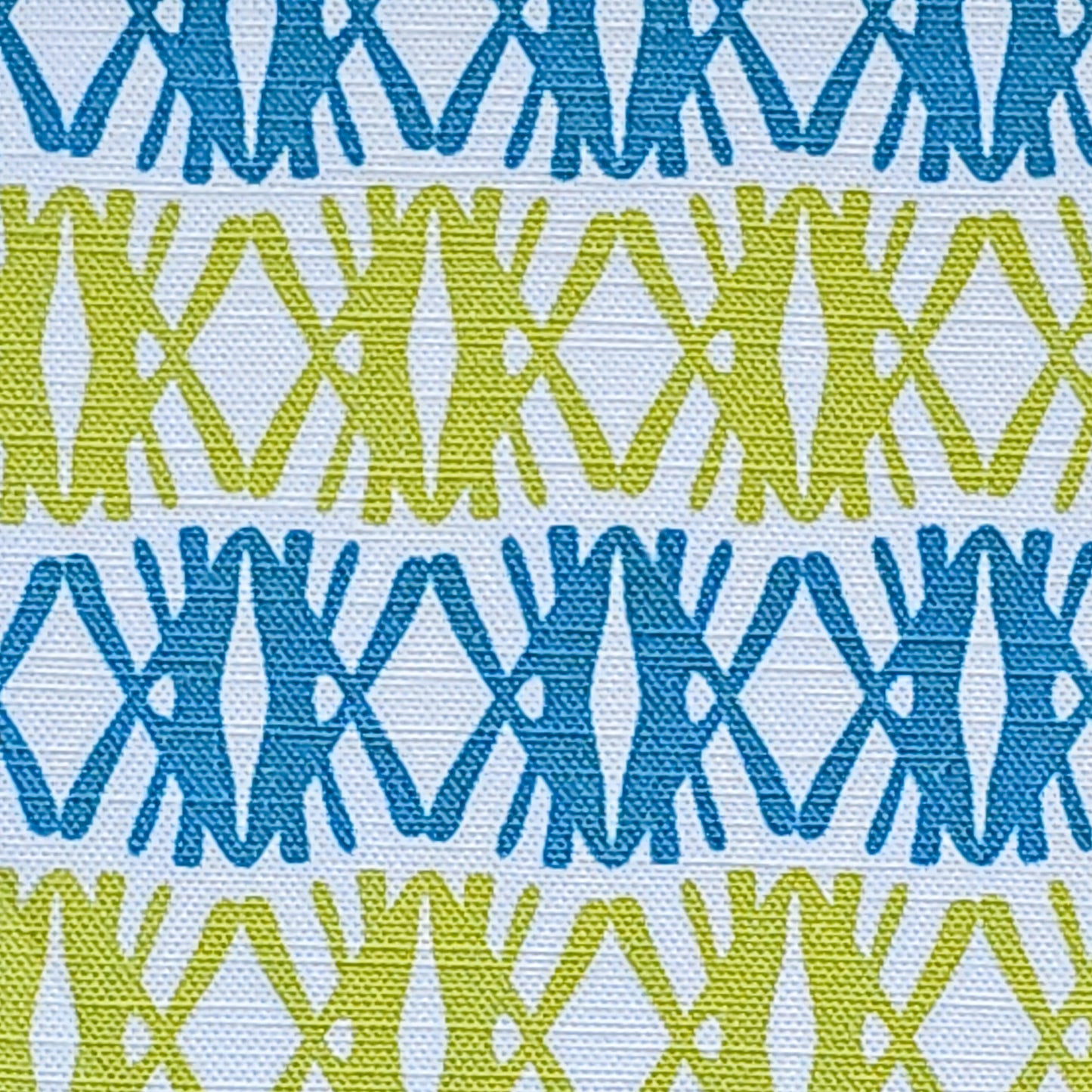 Fabric Swatch. Seagrass print scalloped lampshade by ZIA LIVING, featuring a blue and green geometric lino‑print pattern on a white cotton‑linen.