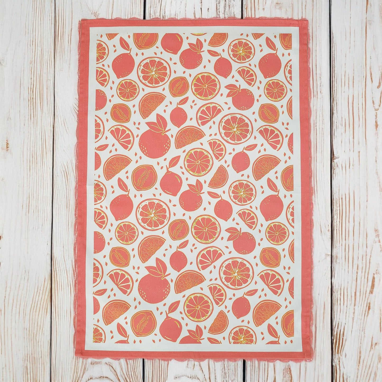 A Moro Orange tea towel from ZIA LIVING arranged flat showing full design on a wooden surface