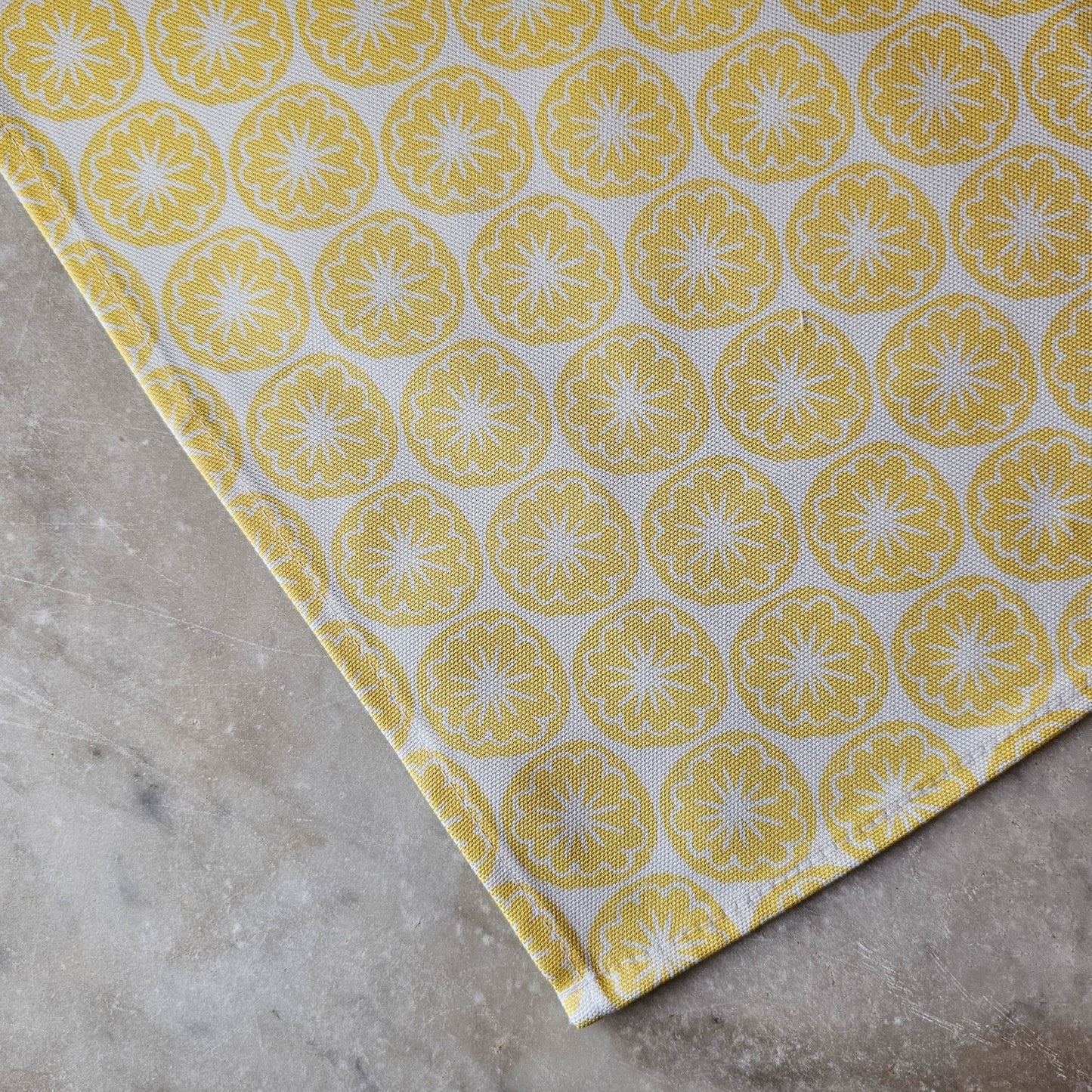 Yellow Seedhead patterned tea towel close up, featuring bold circular yellow botanical motifs on a white background — ZIA LIVING