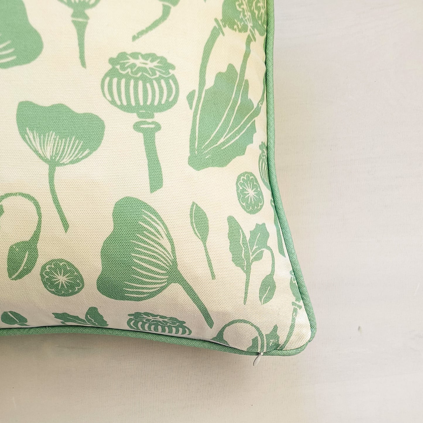 Decorative Zia Living Wild Poppies Print Cushion with green floral pattern on a neutral background - close up