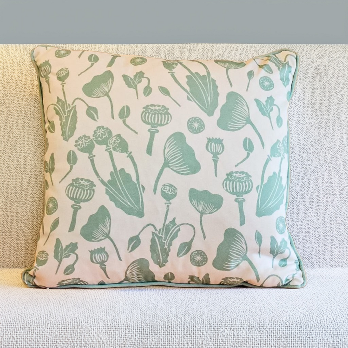 Decorative Zia Living Wild Poppies Print Cushion with green floral pattern on a neutral background
