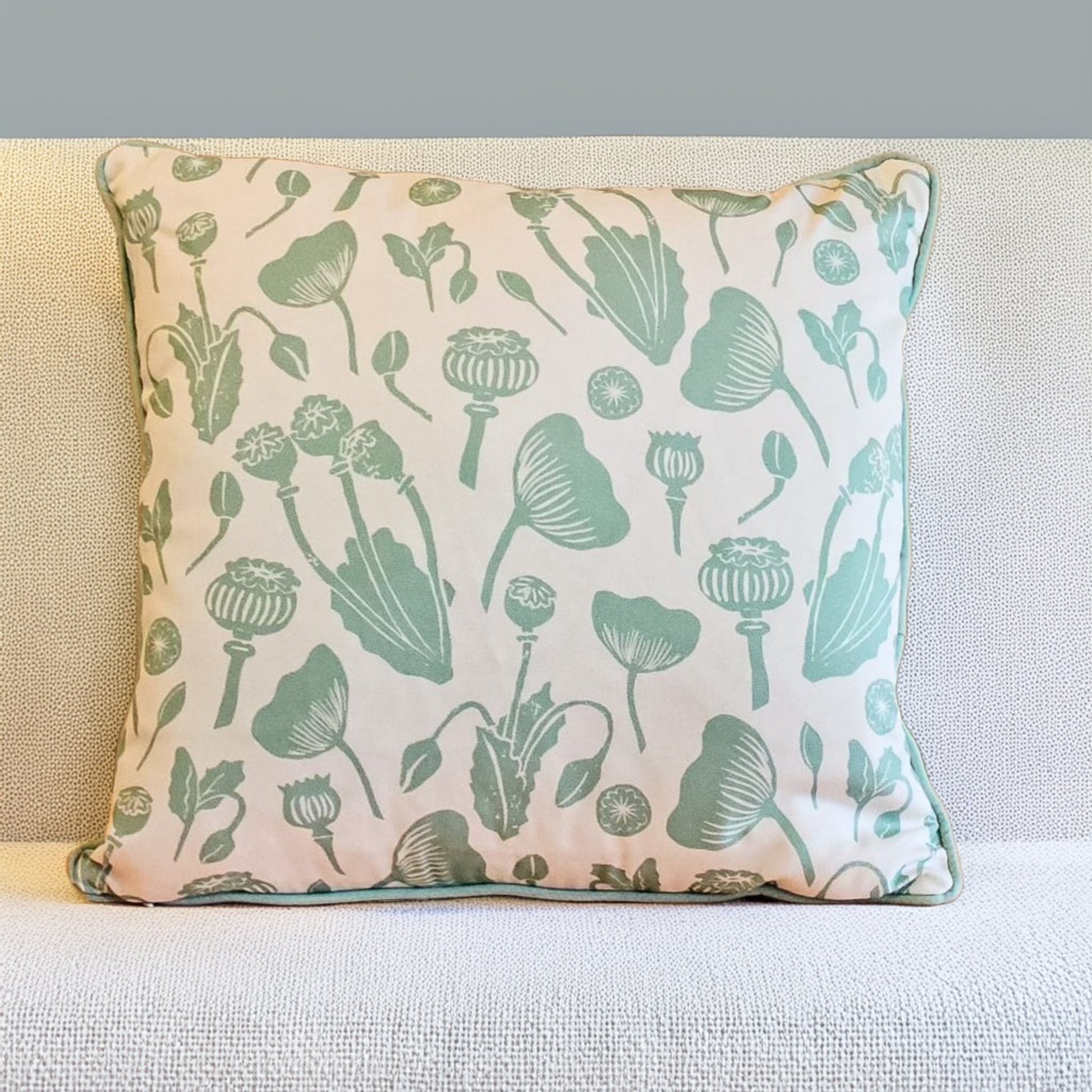 Decorative Zia Living Wild Poppies Print Cushion with green floral pattern on a neutral background