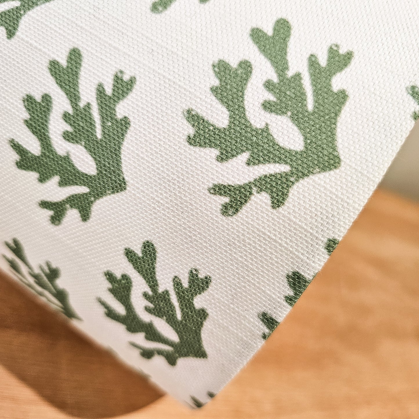 Close-up of a fabric with green seaweed pattern on a white background Handmade drum lampshade — artisan home décor by ZIA LIVING