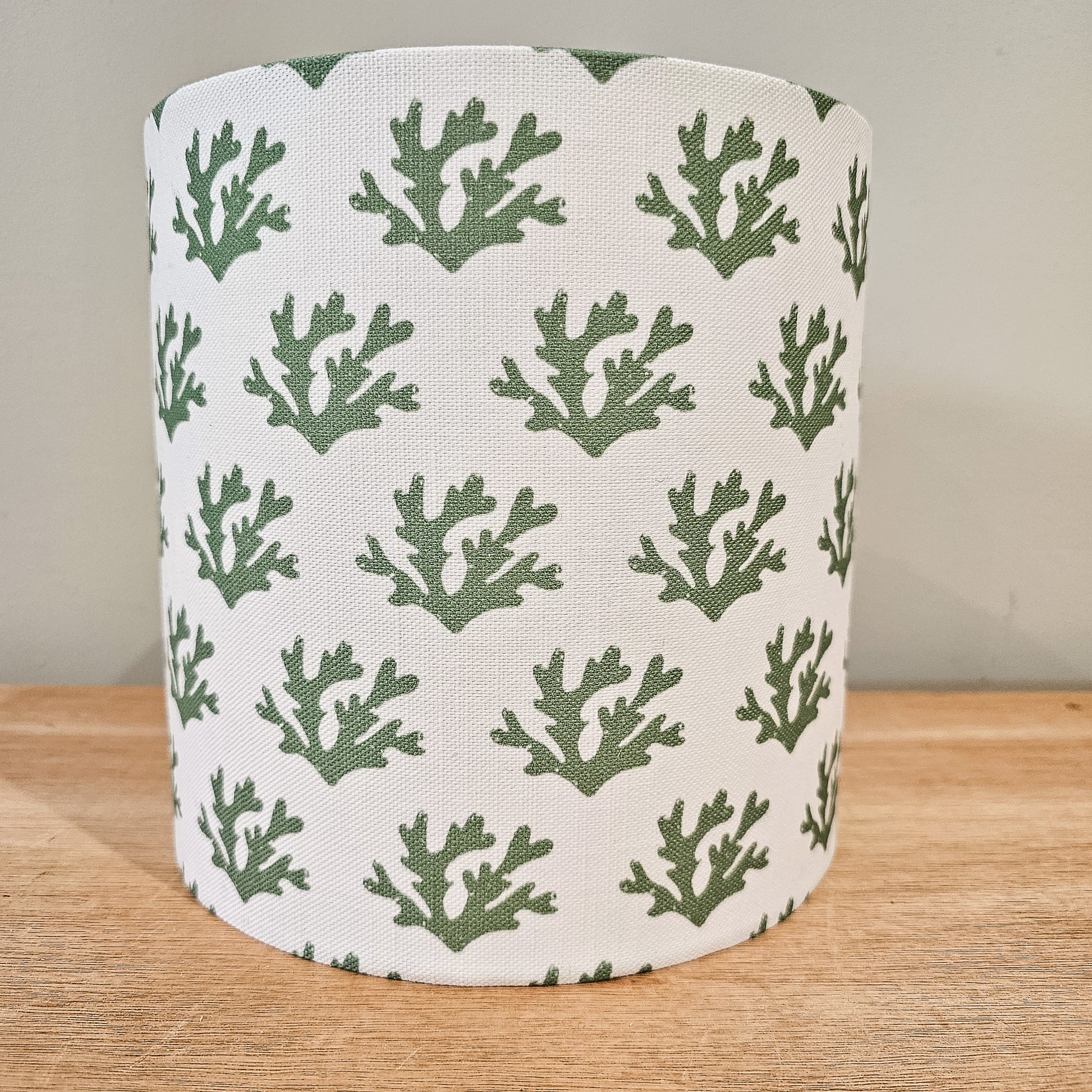 Handmade drum lampshade in green seaweed print fabric on a wooden table — artisan home décor by ZIA LIVING