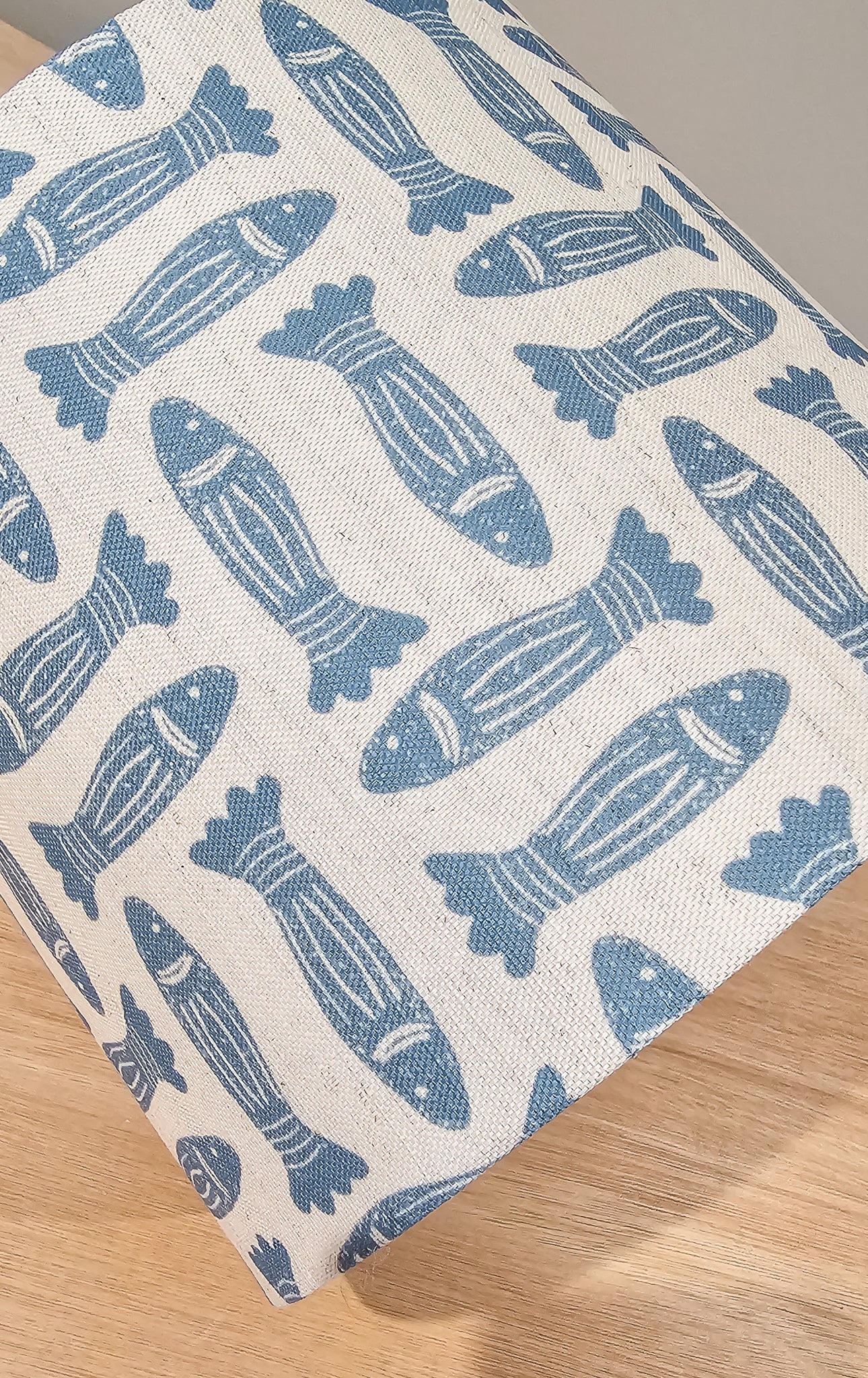 Blue Fishes drum lampshade featuring simple fish motifs on a warm neutral background, styled on a wooden surface — ZIA LIVING.