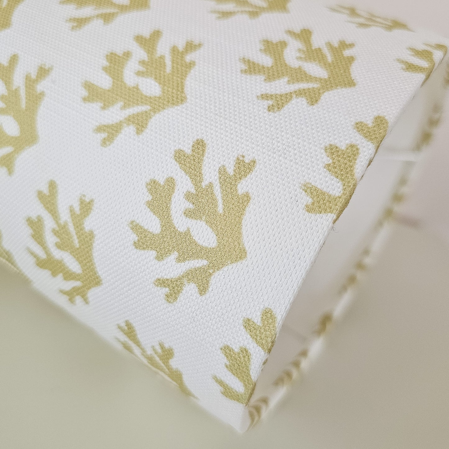 Seaweed motif lampshade by ZIA LIVING, featuring a repeating sand coloured sea‑coral pattern on a white cotton‑linen oval shade. Closeup