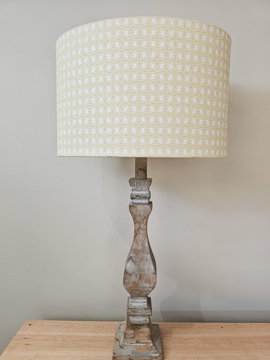 Belle patterned drum lampshade on a carved wooden lamp base, featuring a soft decorative geometric motif in warm neutral tones — ZIA LIVING.