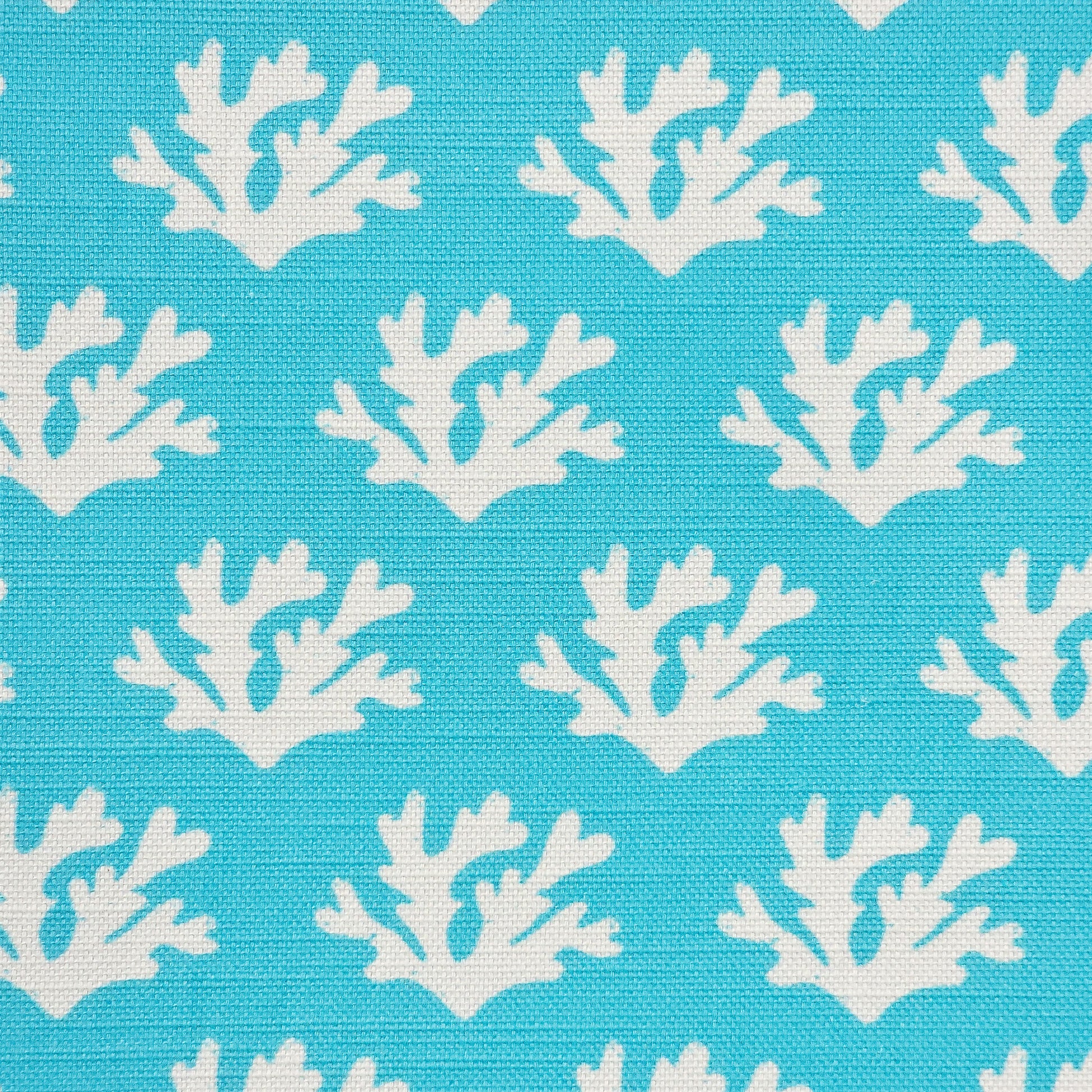 Seaweed cotton linen fabric featuring white lino print seaweed motifs in a repeating coastal pattern on a soft teal coloured background. ZIA LIVING.