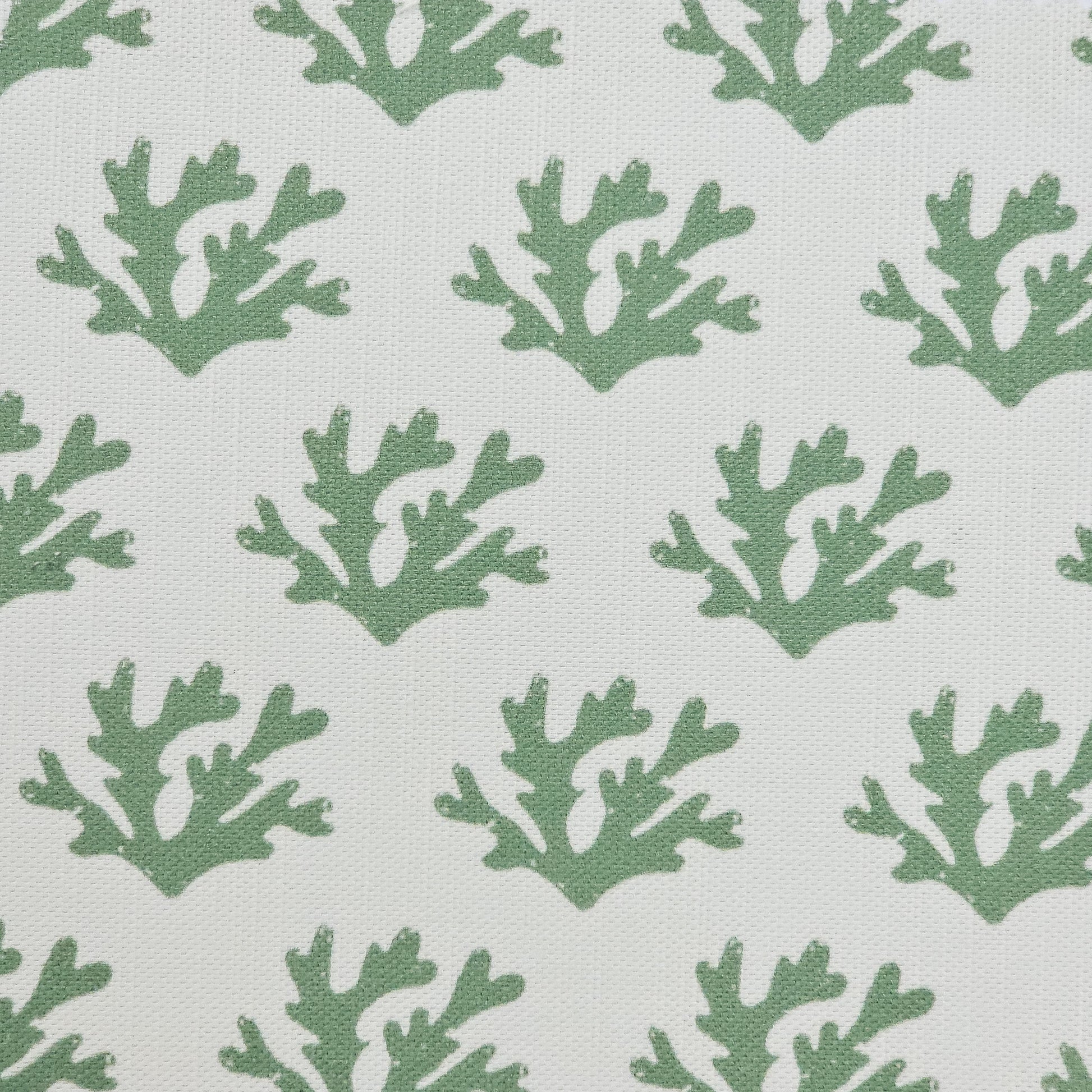 Green Seaweed cotton linen fabric featuring green coloured hand carved lino print seaweed motifs in a repeating coastal pattern on a soft white background. ZIA LIVING.