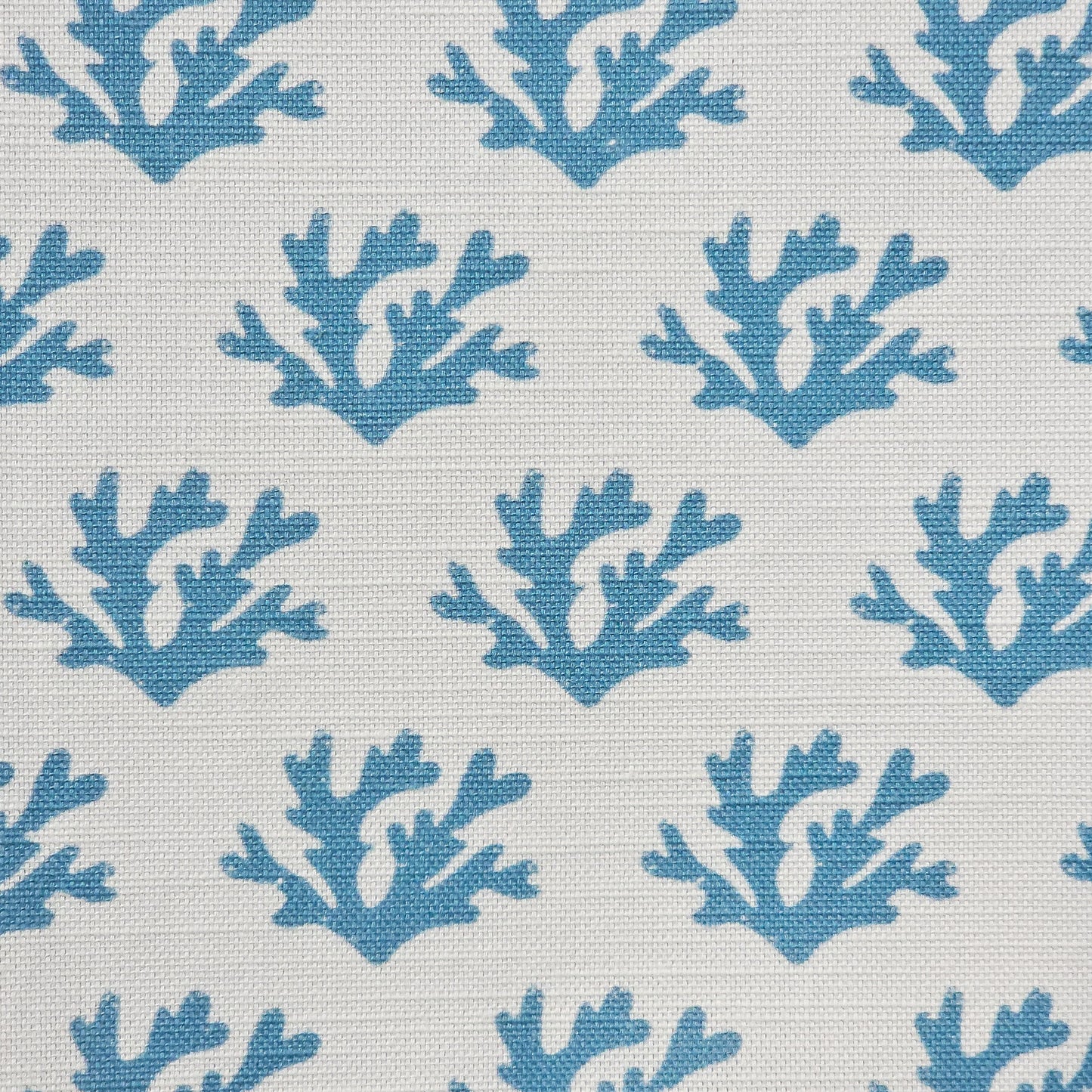 Sea Blue Seaweed cotton linen fabric featuring sea blue coloured hand carved lino print seaweed motifs in a repeating coastal pattern on a soft white background. ZIA LIVING.