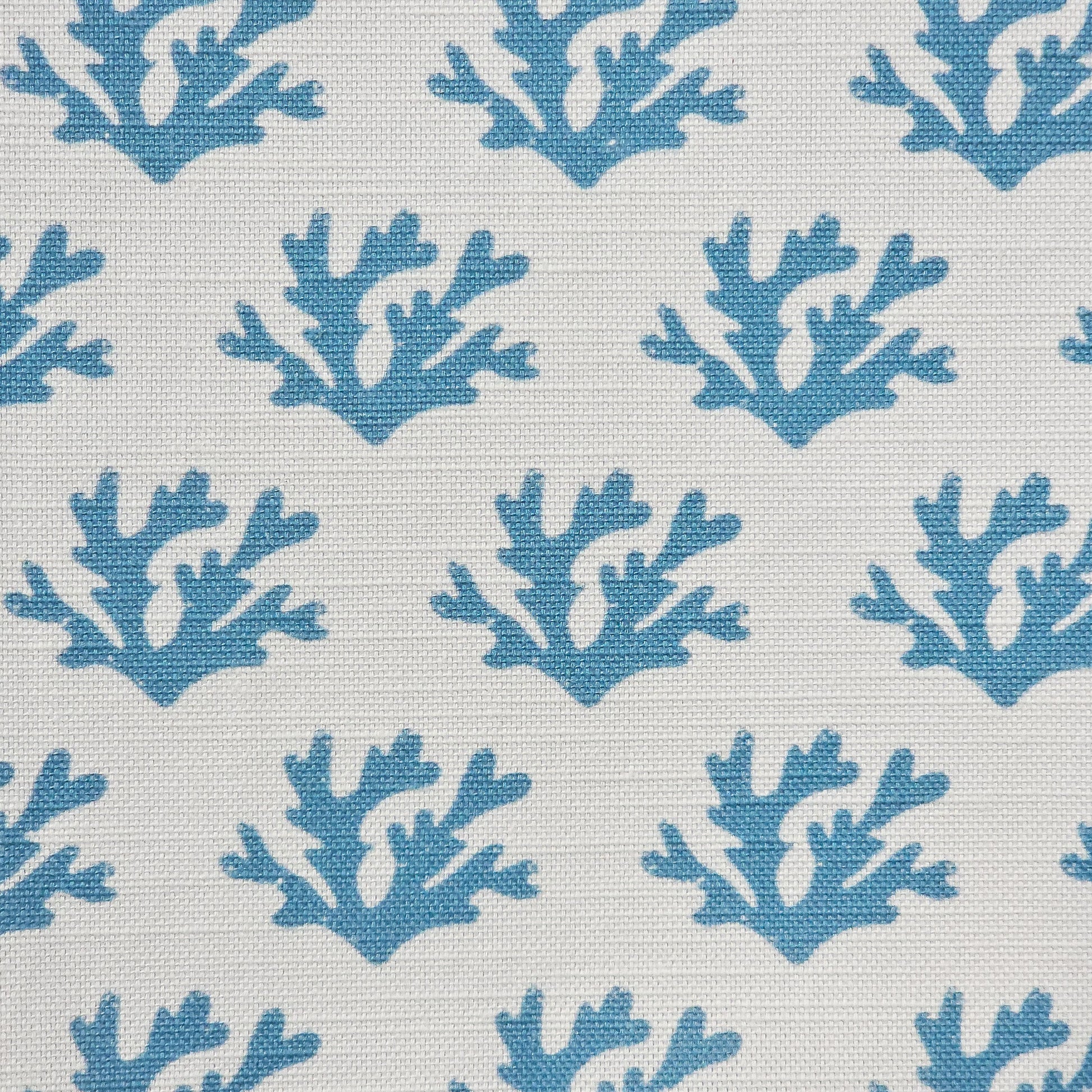 Sea Blue Seaweed cotton linen fabric featuring sea blue coloured hand carved lino print seaweed motifs in a repeating coastal pattern on a soft white background. ZIA LIVING.