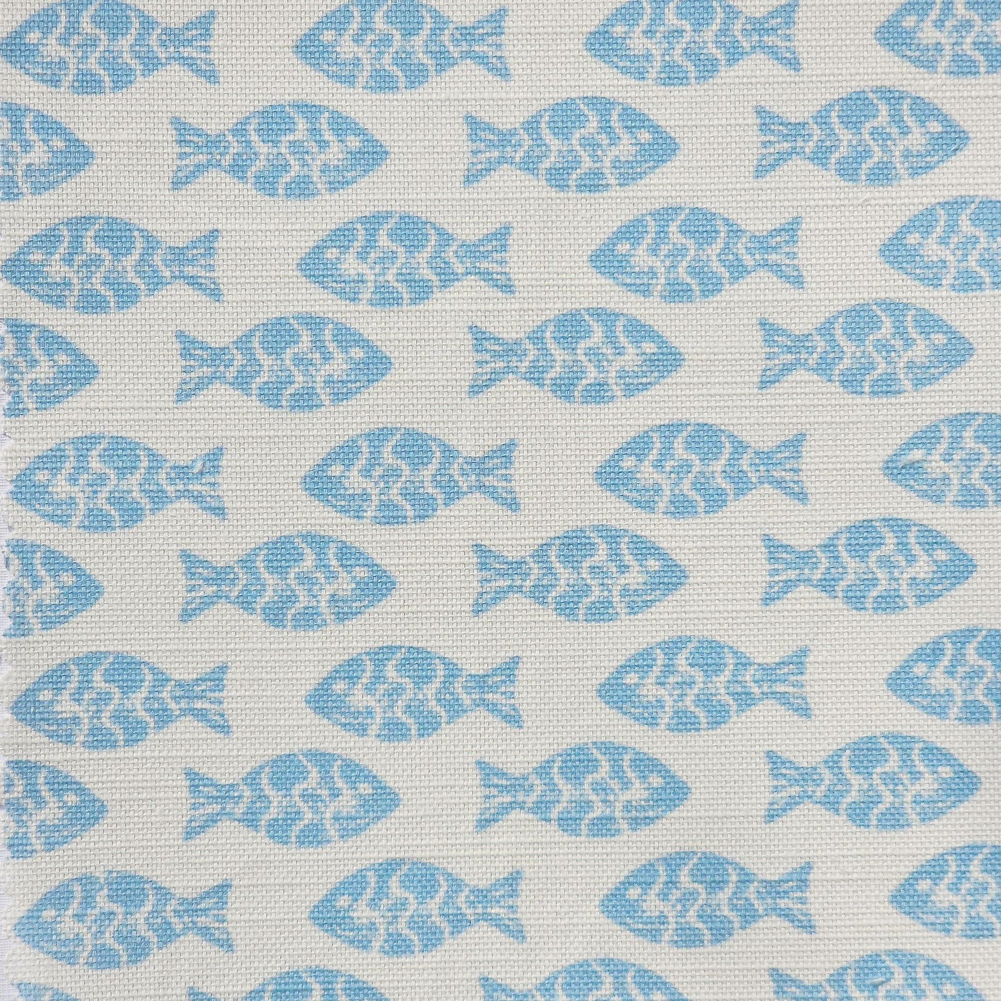 Pattern of blue fish shapes on a light white fabric background