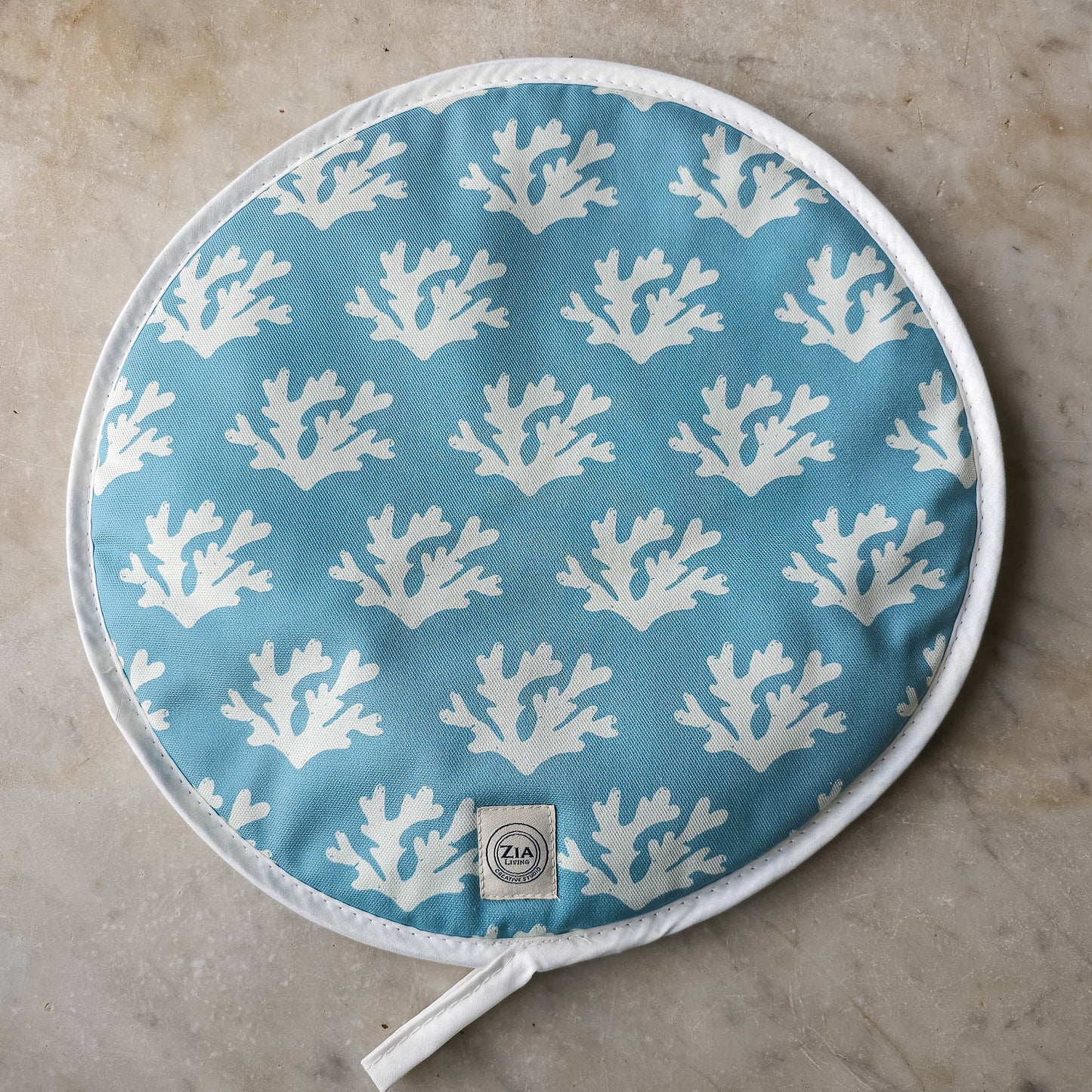 Blue seaweed print Aga and hob covers by ZIA LIVING, featuring a white coral motif on a deep‑blue cotton base, shown on marble worktop