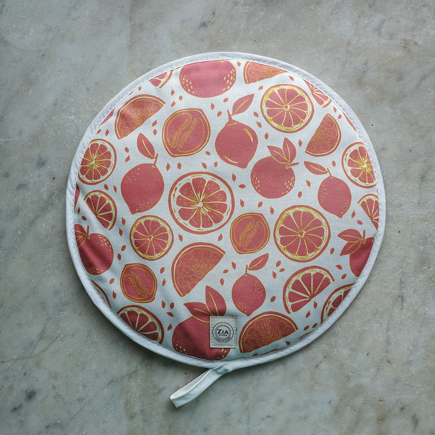 Citrus print round kitchen cover by ZIA LIVING, featuring orange and grapefruit motifs on a white cotton‑linen base, shown on marble top