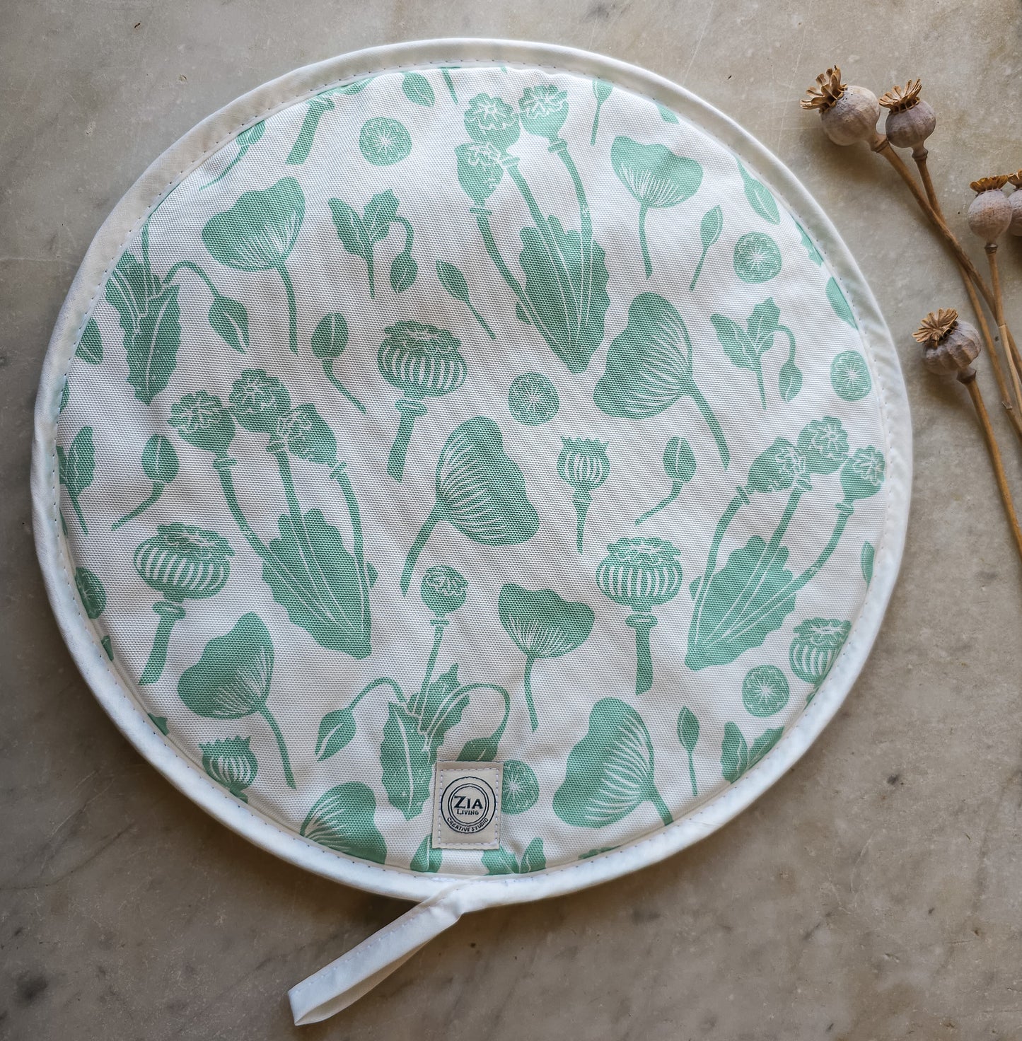 Green botanical print Aga and hob covers by ZIA LIVING, featuring a cream cotton‑linen base with stylised green floral motifs, shown on a marble worktop