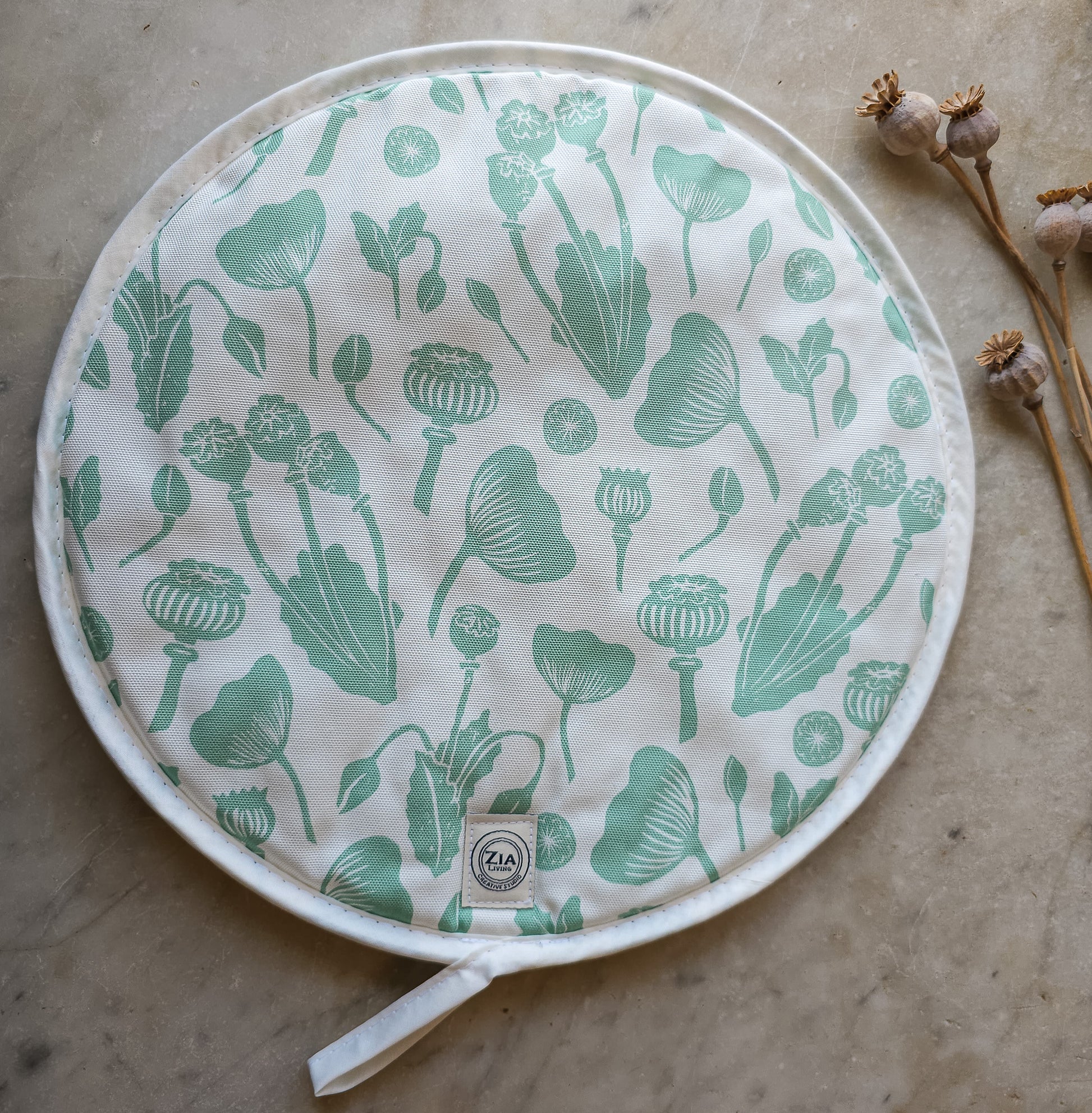 Green botanical print Aga and hob covers by ZIA LIVING, featuring a cream cotton‑linen base with stylised green floral motifs, shown on a marble worktop