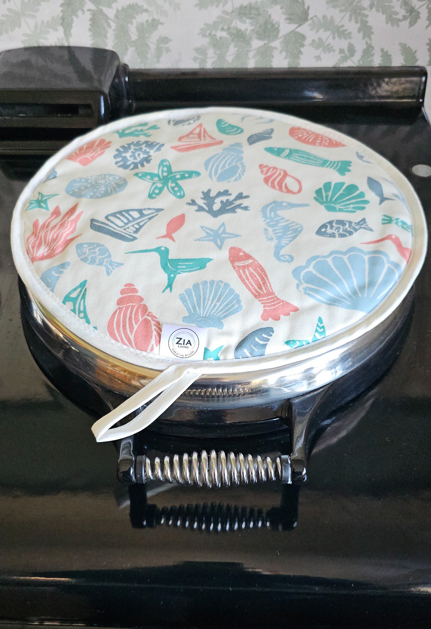 Under the Sea round Aga and hob cover by ZIA LIVING, featuring a colourful coastal lino‑print pattern with sea creatures, shells and boats on cotton, shown on Aga hob.