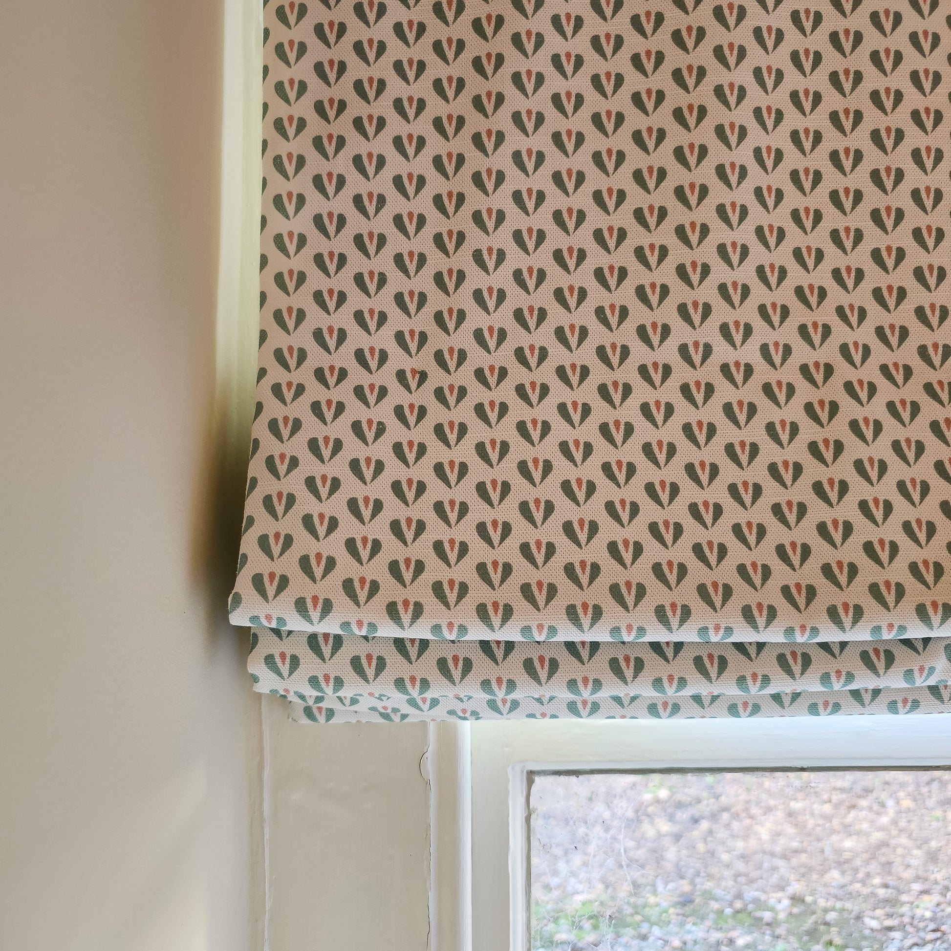 Carina hearts pattern by Zia Living, shown as a roman blind 