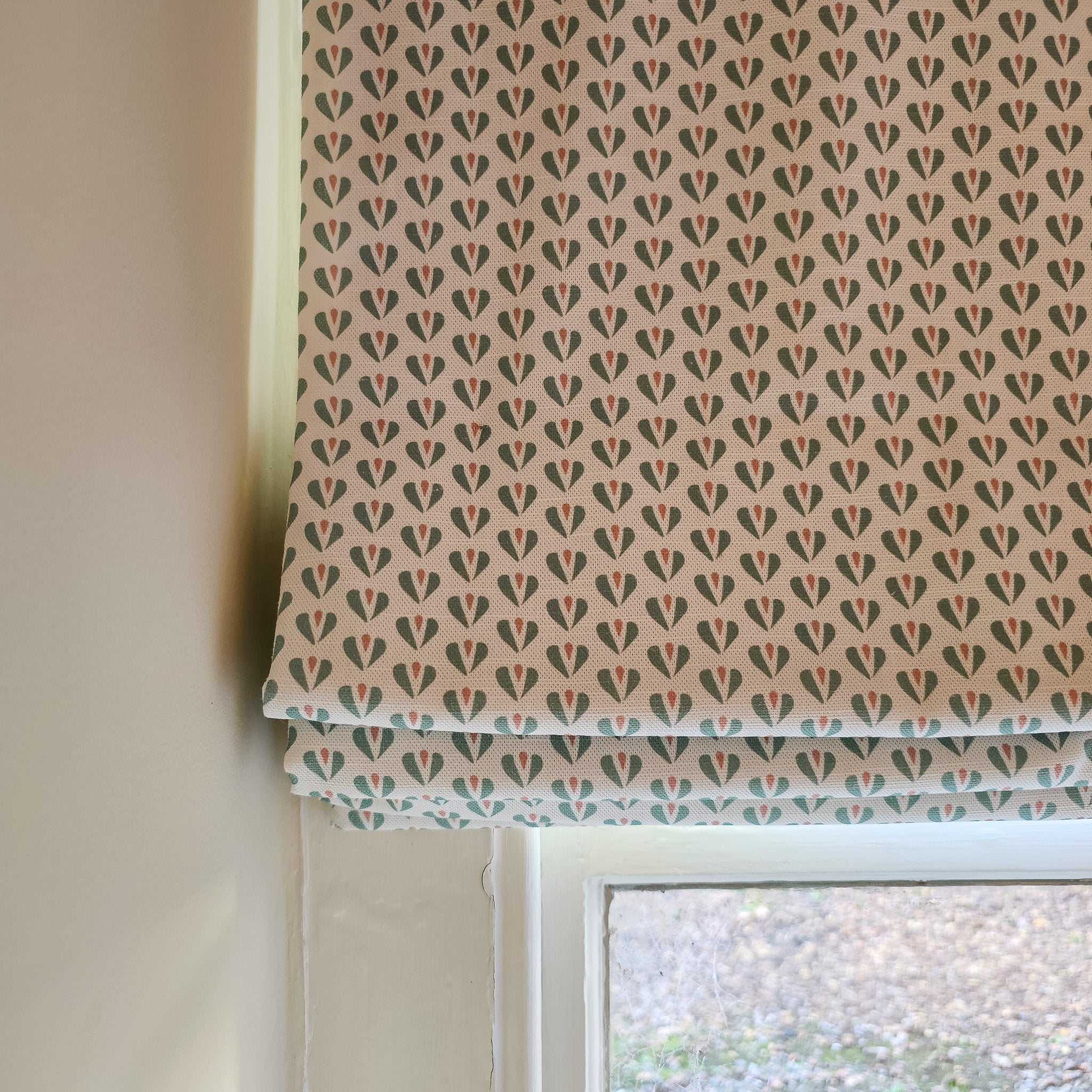 Carina hearts pattern by Zia Living, shown as a roman blind 