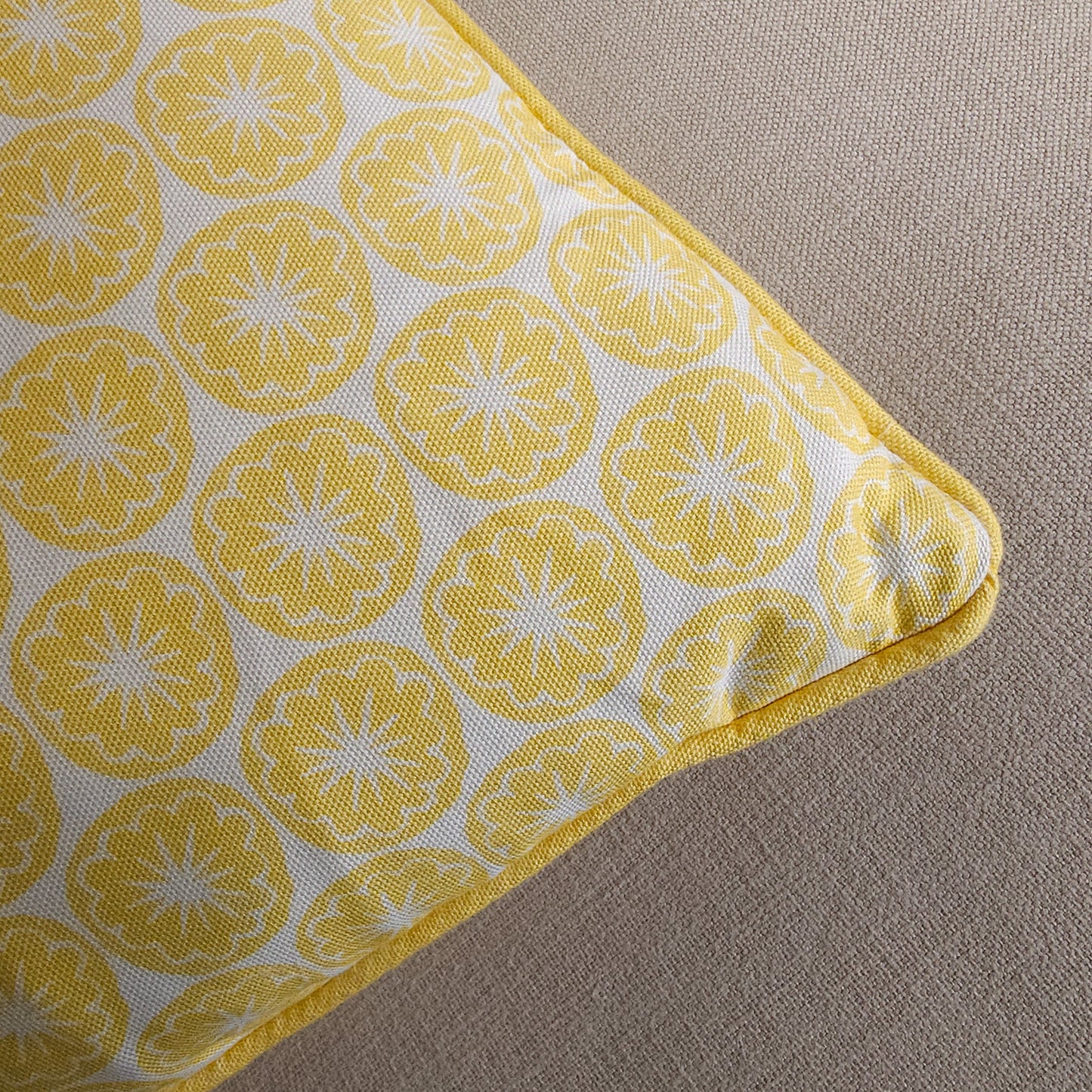 Yellow Seedhead patterned cushion, featuring bold circular yellow botanical motifs on a white background, close up— ZIA LIVING