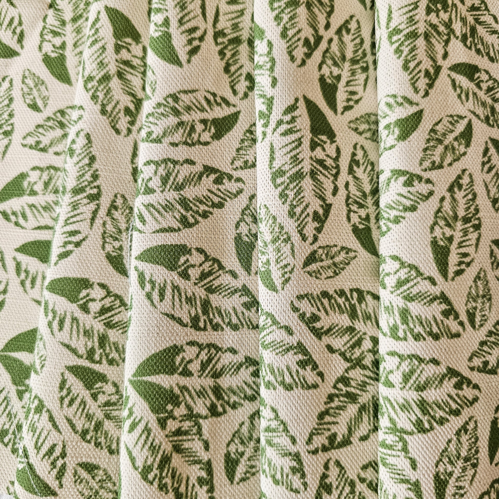 Zia Living, leaf print fabric is green featured on draped fabric