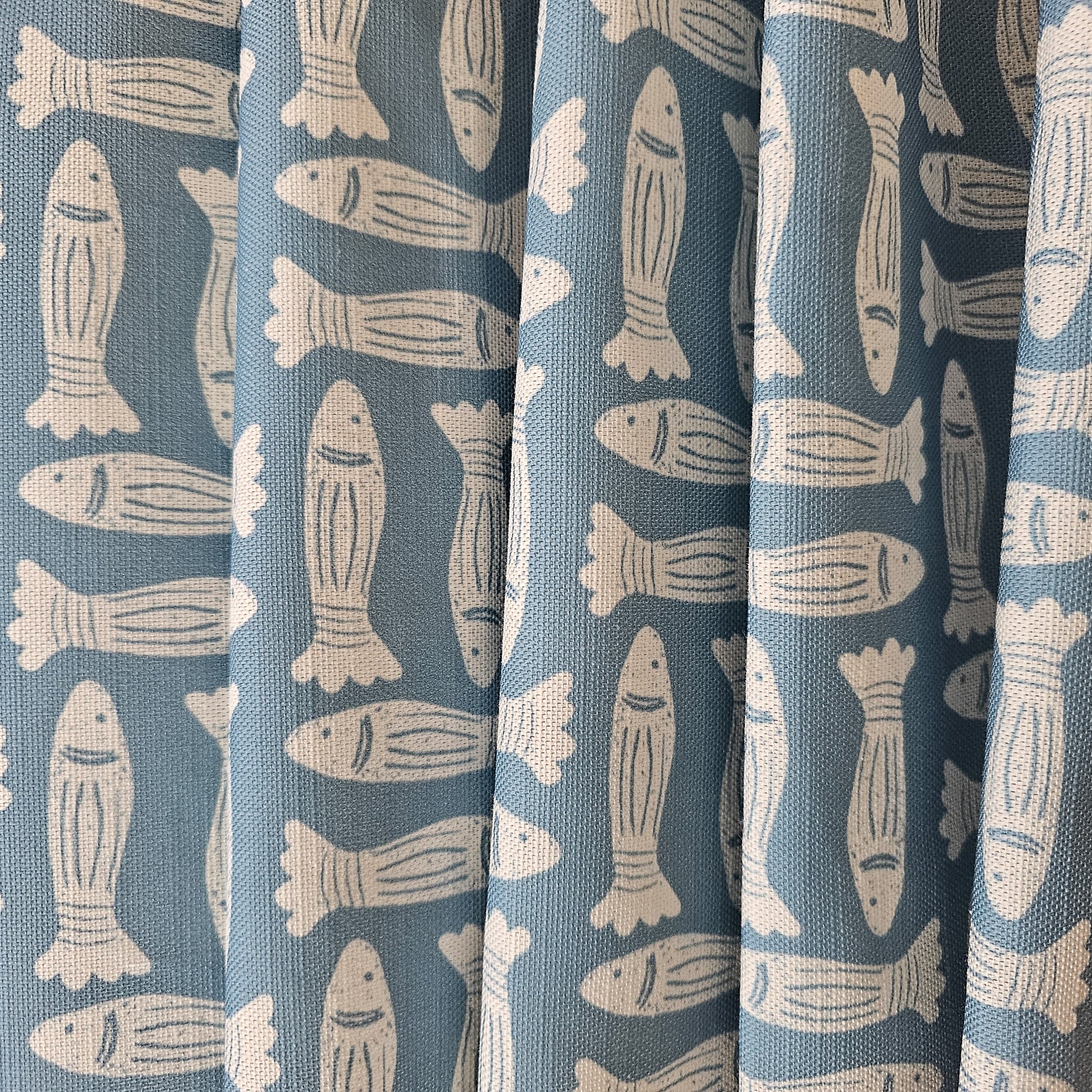 Zia Living, Fishes print fabric in blue, featured as fabric drapes.