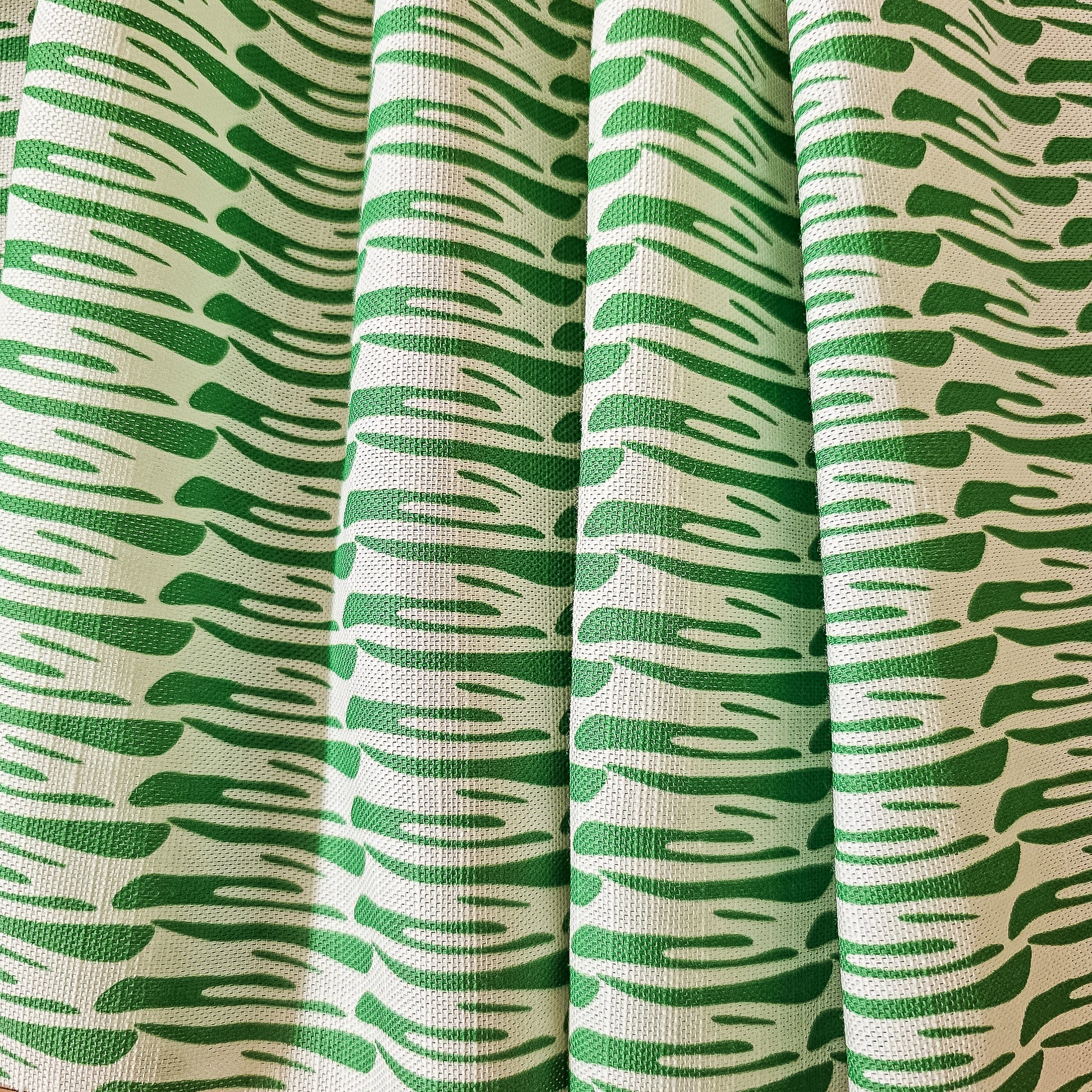 Ondina green wave‑pattern cotton‑linen fabric by ZIA LIVING, featuring a repeating lino‑style motif on a white background.