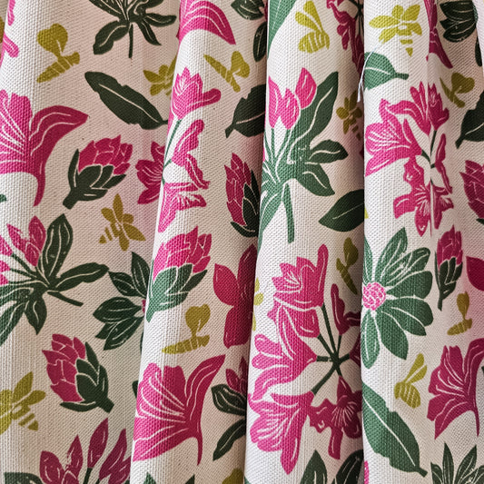 Floral rhododendron fabric pattern with pink and green flowers on a beige background, featured as draped fabric - Zia Living 