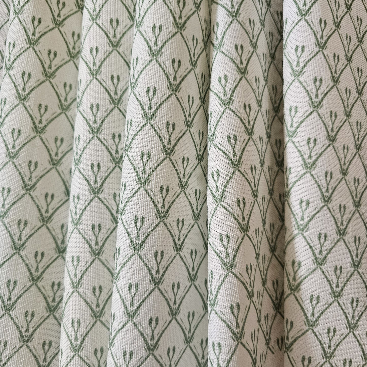 Rosemary Classic cotton‑linen fabric with a white background and green coloured repeat featured as curtains— ZIA LIVING.