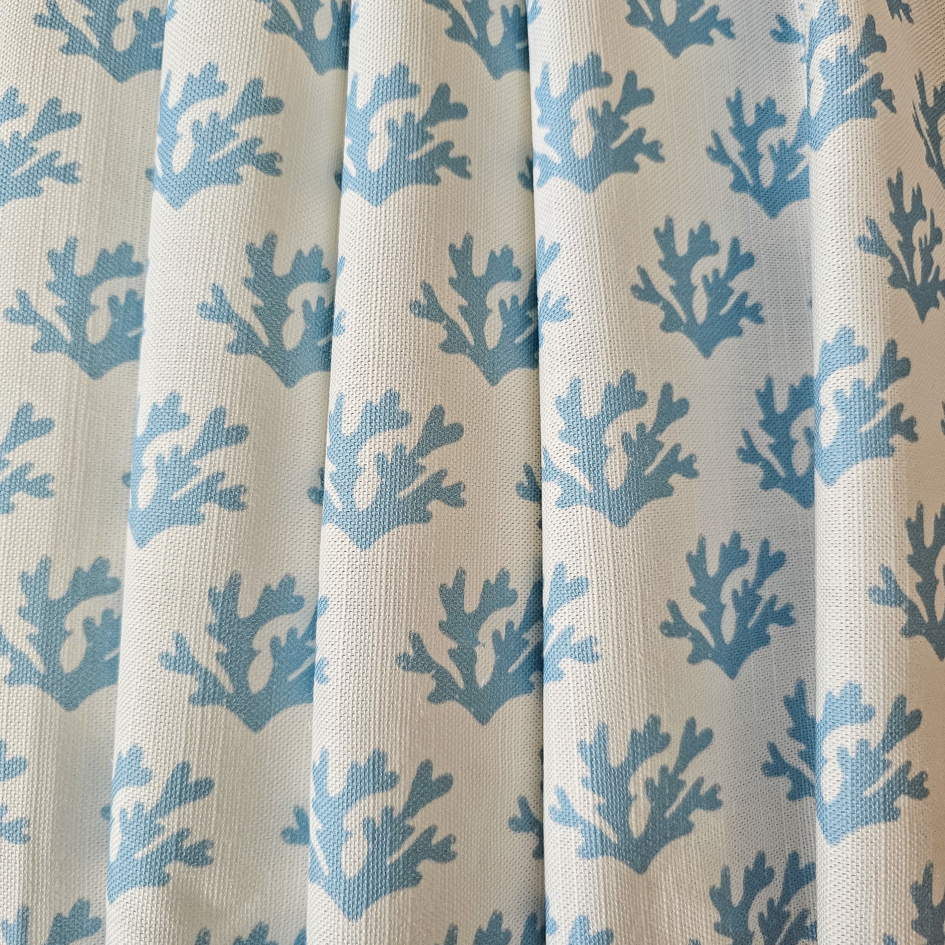 sky blue seaweed print draped fabric on white background by Zia Living