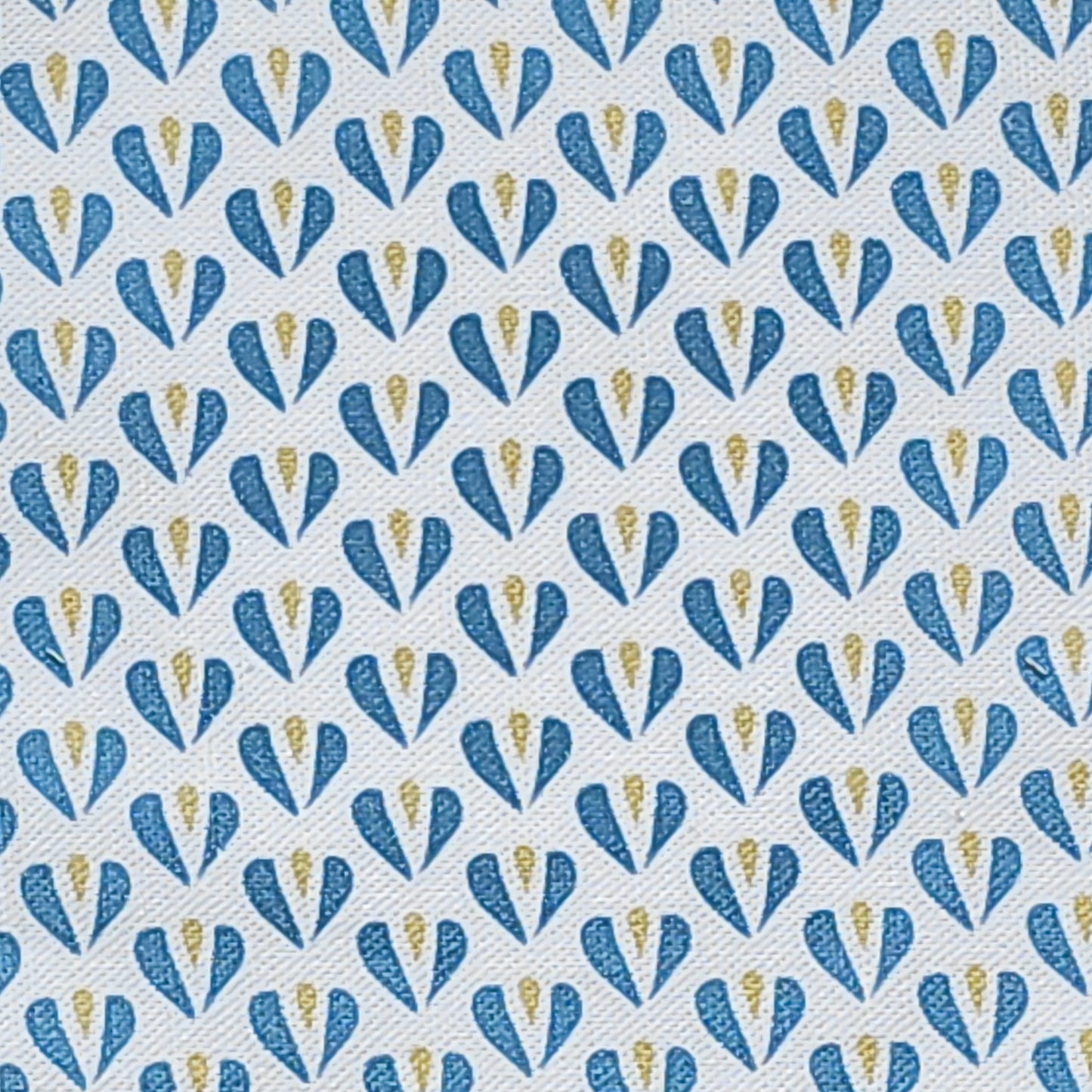 Carina, heart shaped motif in blue and sand colours on neutral fabric, shown as fabric swatch, by Zia Living
