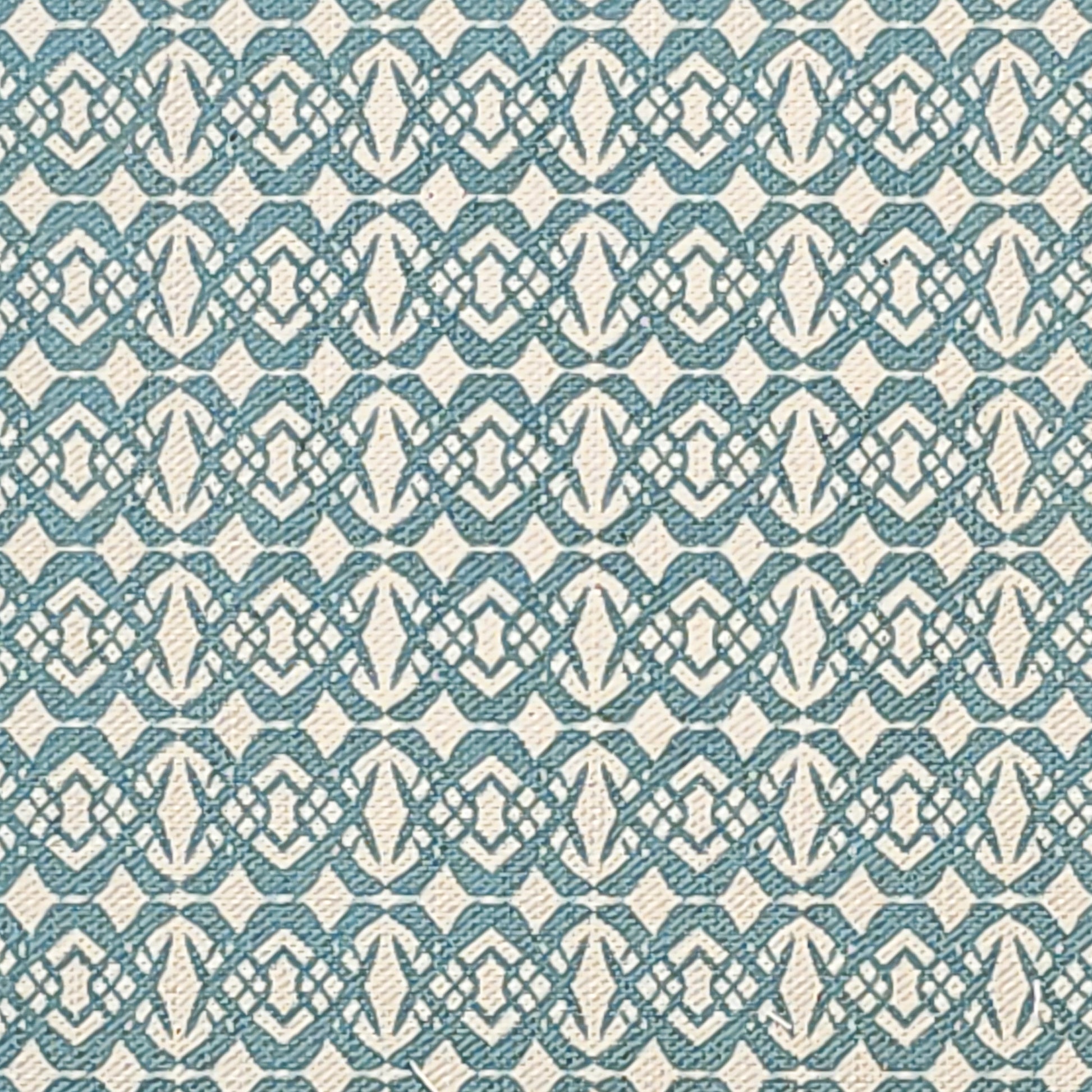 Fornet cotton linen fabric featuring a repeating blue interlocking geometric motif on an off‑white background. ZIA LIVING.