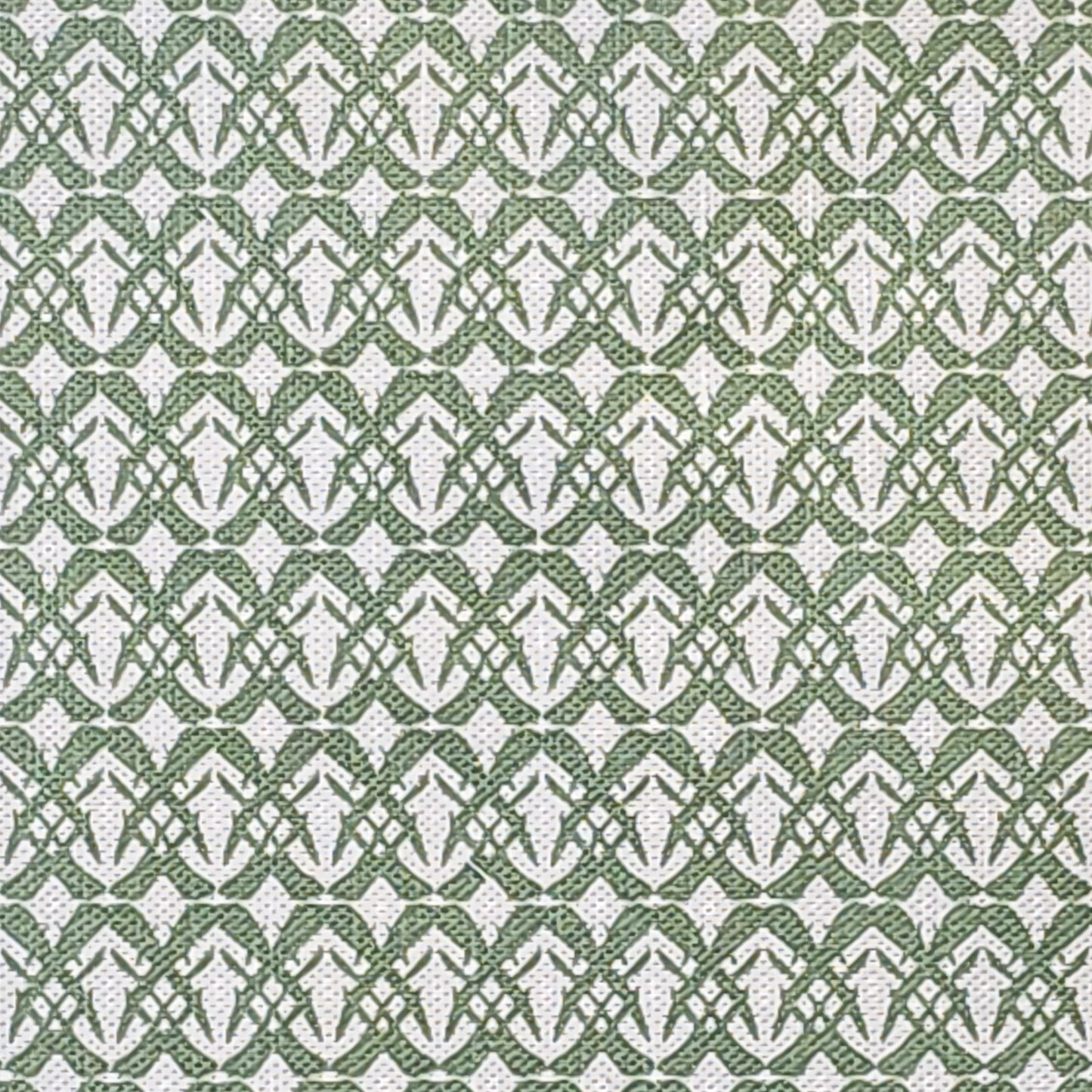 Fornet cotton linen fabric featuring a repeating green interlocking geometric motif on an off‑white background. ZIA LIVING.