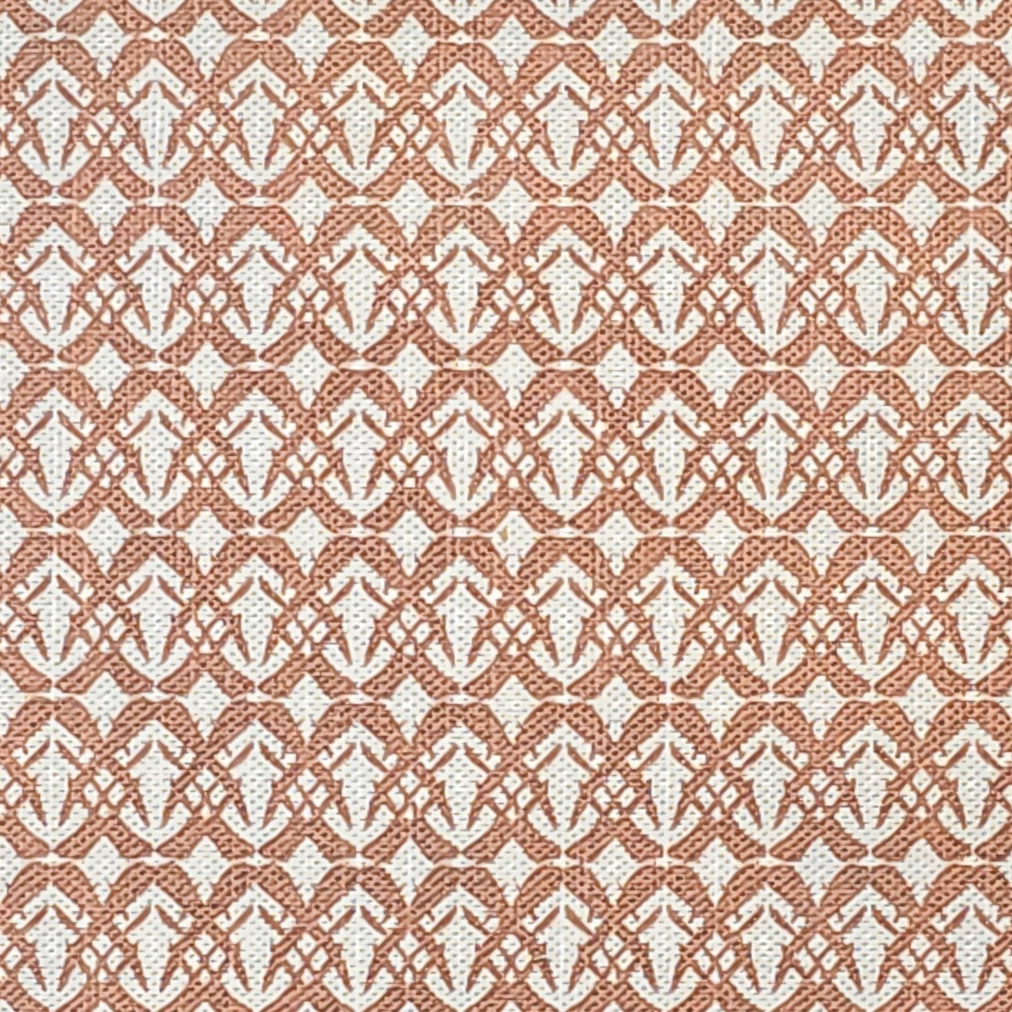 Fornet cotton linen fabric featuring a repeating rust interlocking geometric motif on an off‑white background. ZIA LIVING.