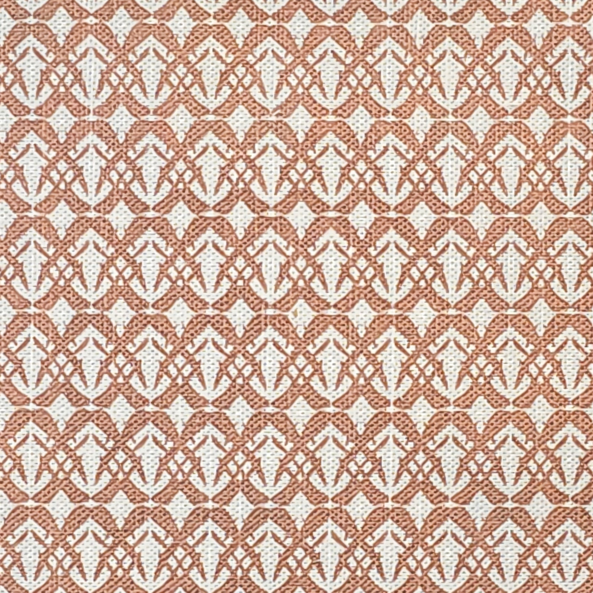 Fornet cotton linen fabric featuring a repeating rust interlocking geometric motif on an off‑white background. ZIA LIVING.