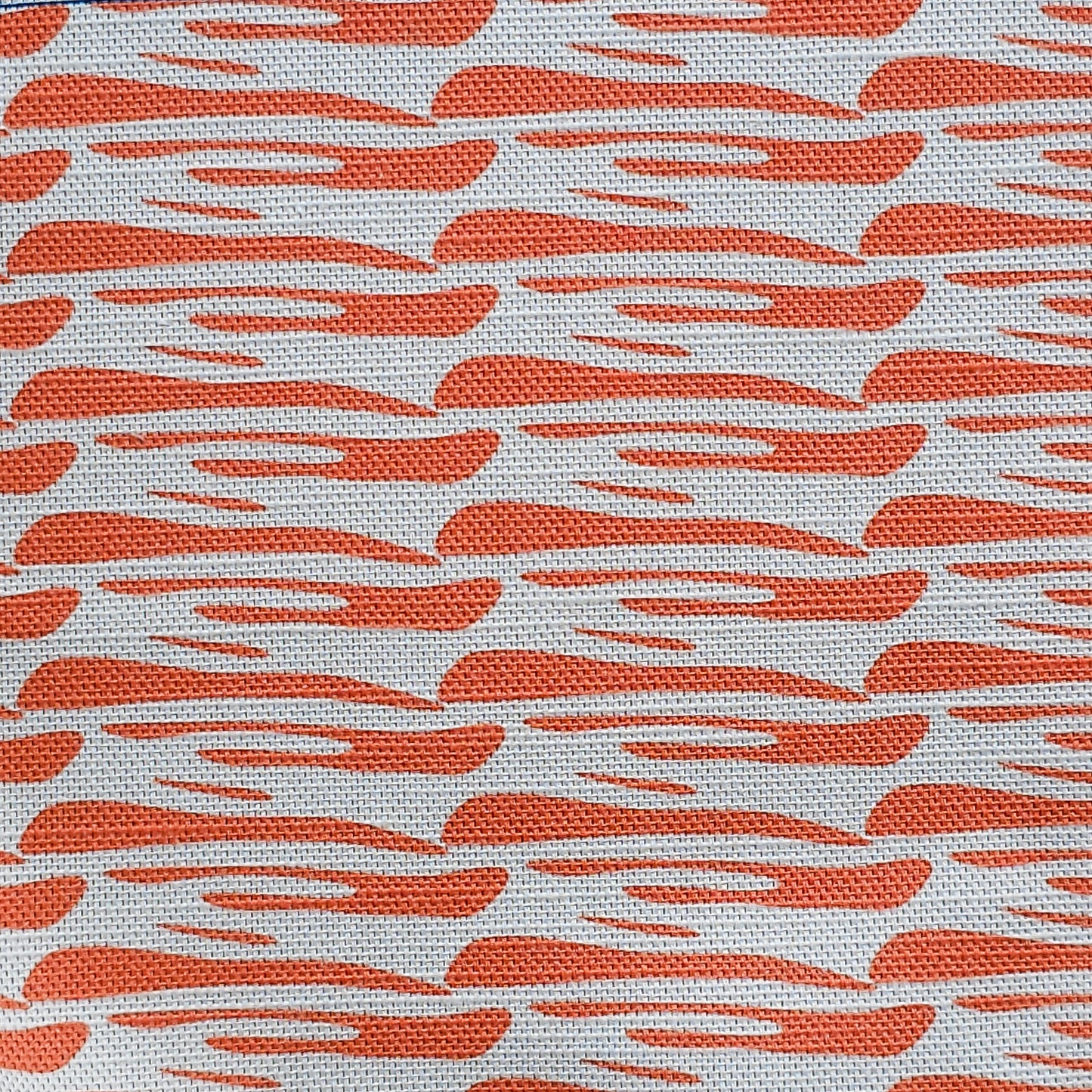Ondina orange wave‑pattern cotton‑linen fabric by ZIA LIVING, featuring a repeating lino‑style motif on a white background.