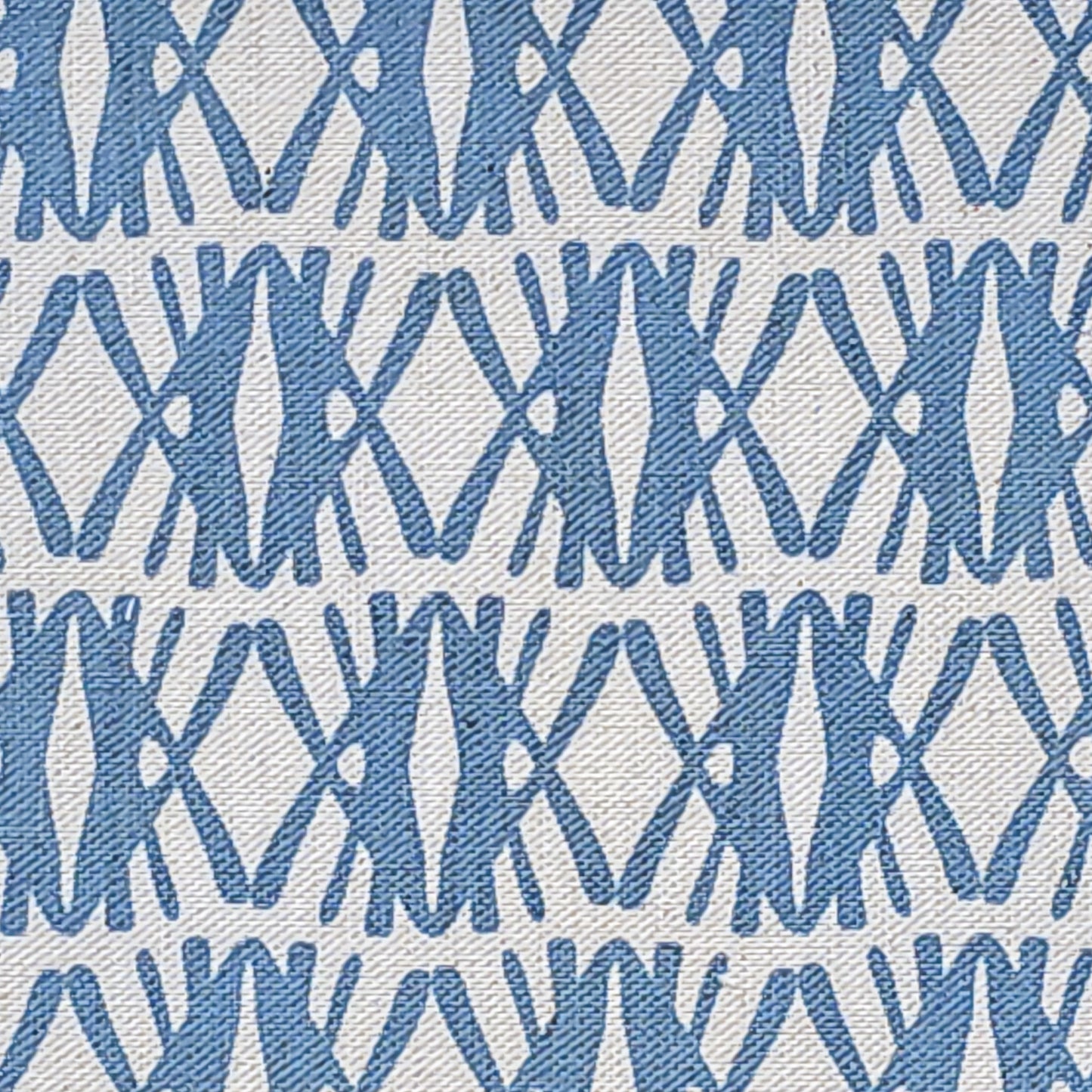 Seagrass cotton linen fabric featuring interlocking  blue woven‑style motifs in a repeating geometric pattern on a natural background. ZIA LIVING.