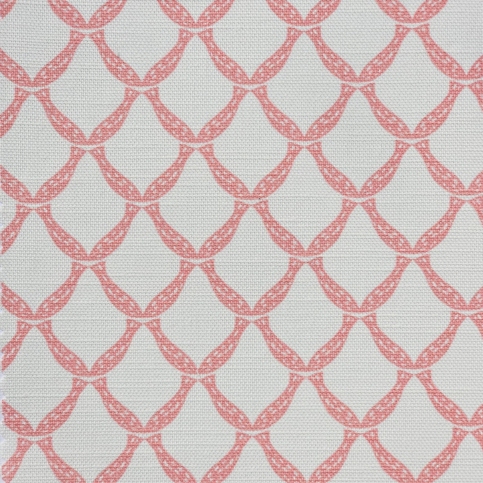 Marina cotton linen fabric featuring a repeating coral curved geometric trellis motif on an off‑white textured background. ZIA LIVING.