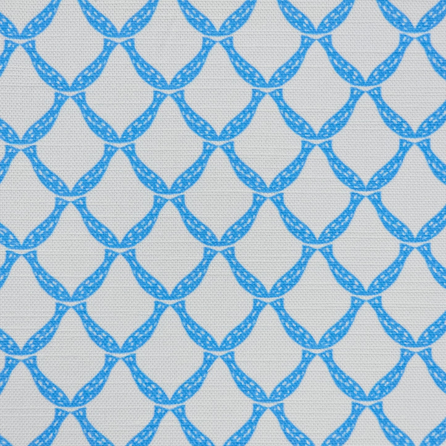 Marina cotton linen fabric featuring an interlocking curved bright blue lattice pattern on an off‑white background. ZIA LIVING