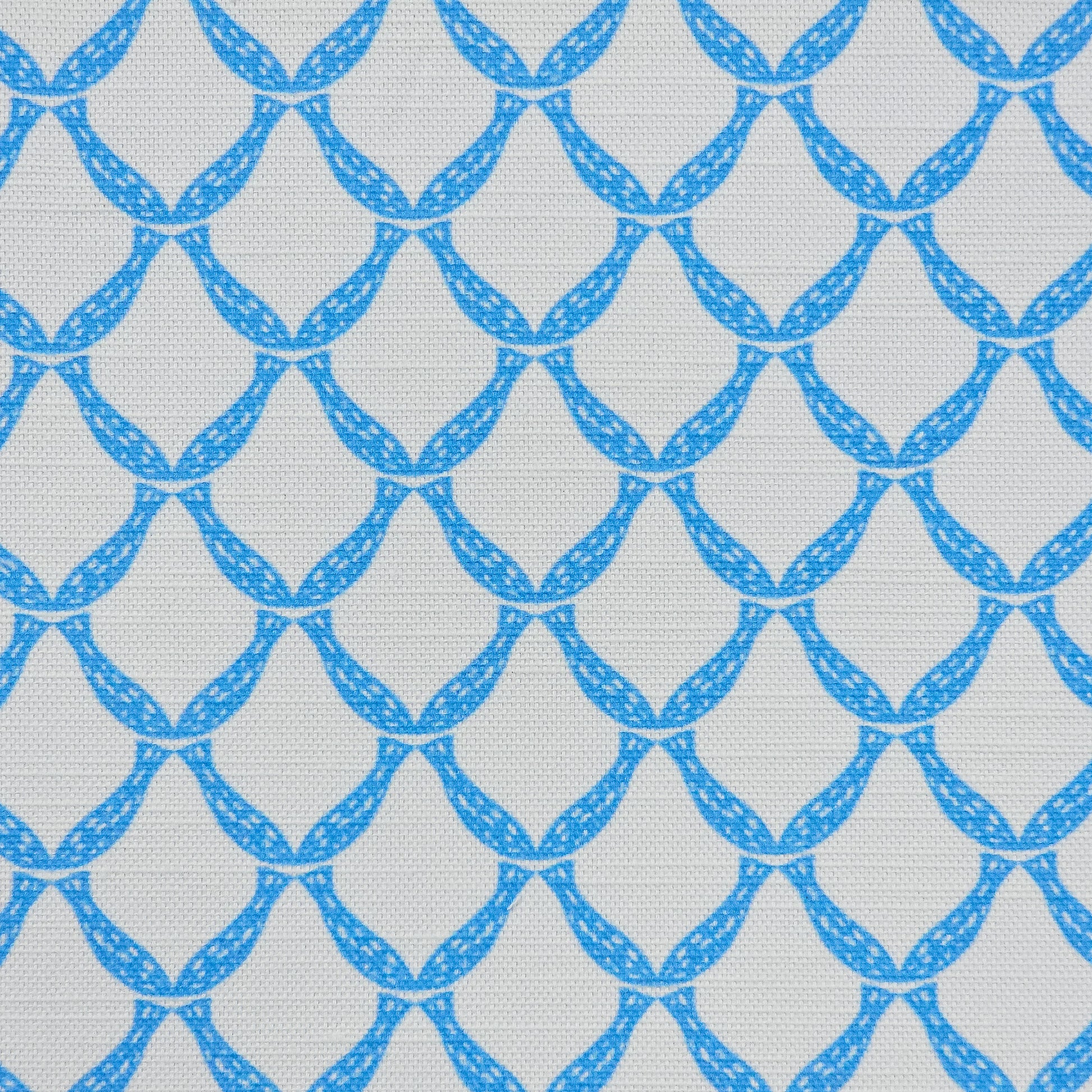 Marina cotton linen fabric featuring an interlocking curved bright blue lattice pattern on an off‑white background. ZIA LIVING