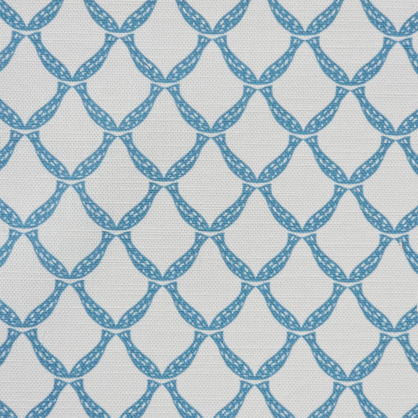 Marina cotton linen fabric featuring a repeating blue curved geometric trellis motif on an off‑white textured background. ZIA LIVING.