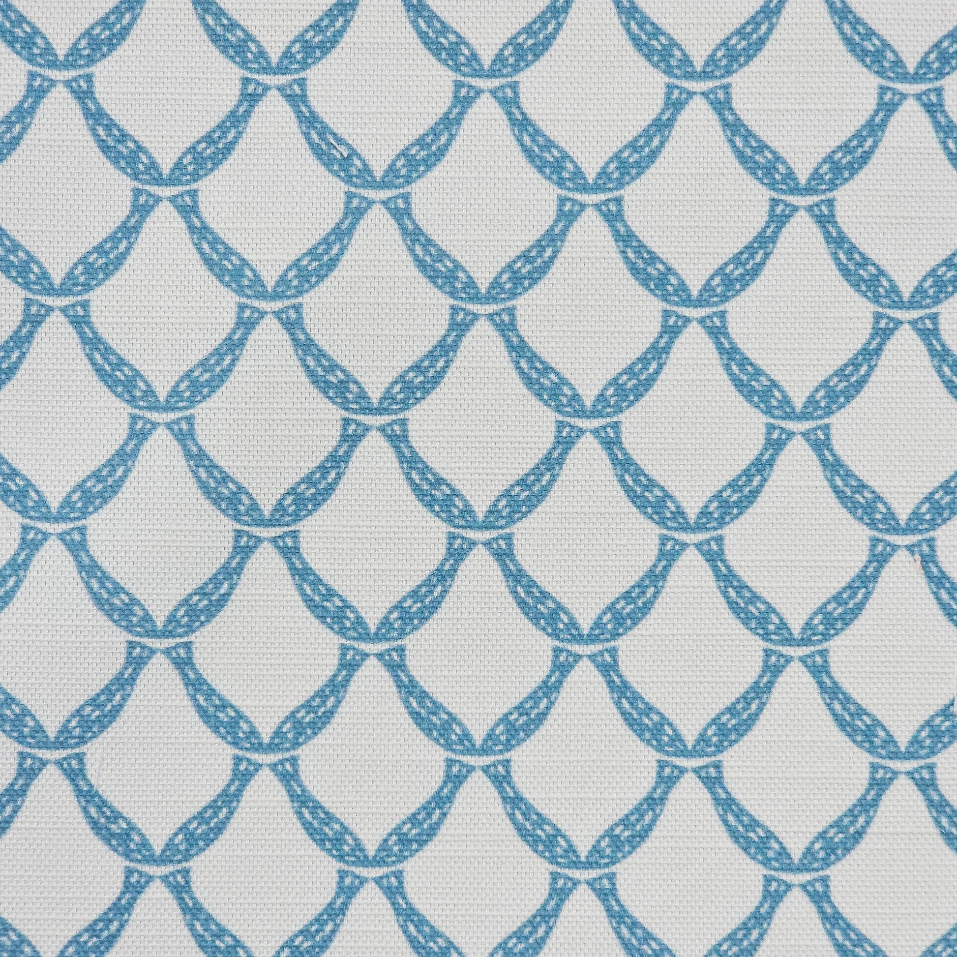 Marina cotton linen fabric featuring a repeating blue curved geometric trellis motif on an off‑white textured background. ZIA LIVING.
