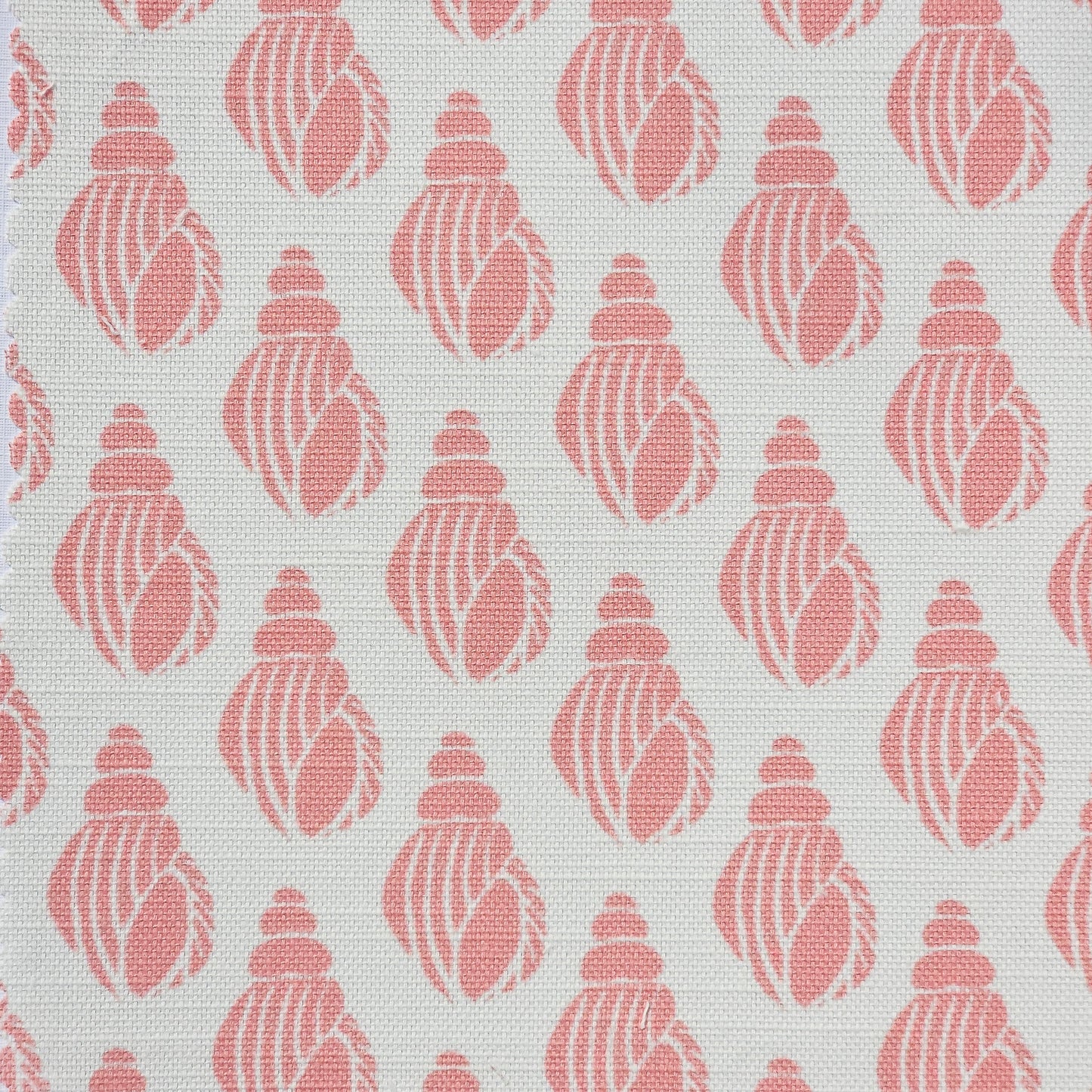 Shell lino print design cotton linen fabric featuring shell motifs in soft coral on an off‑white background. ZIA LIVING