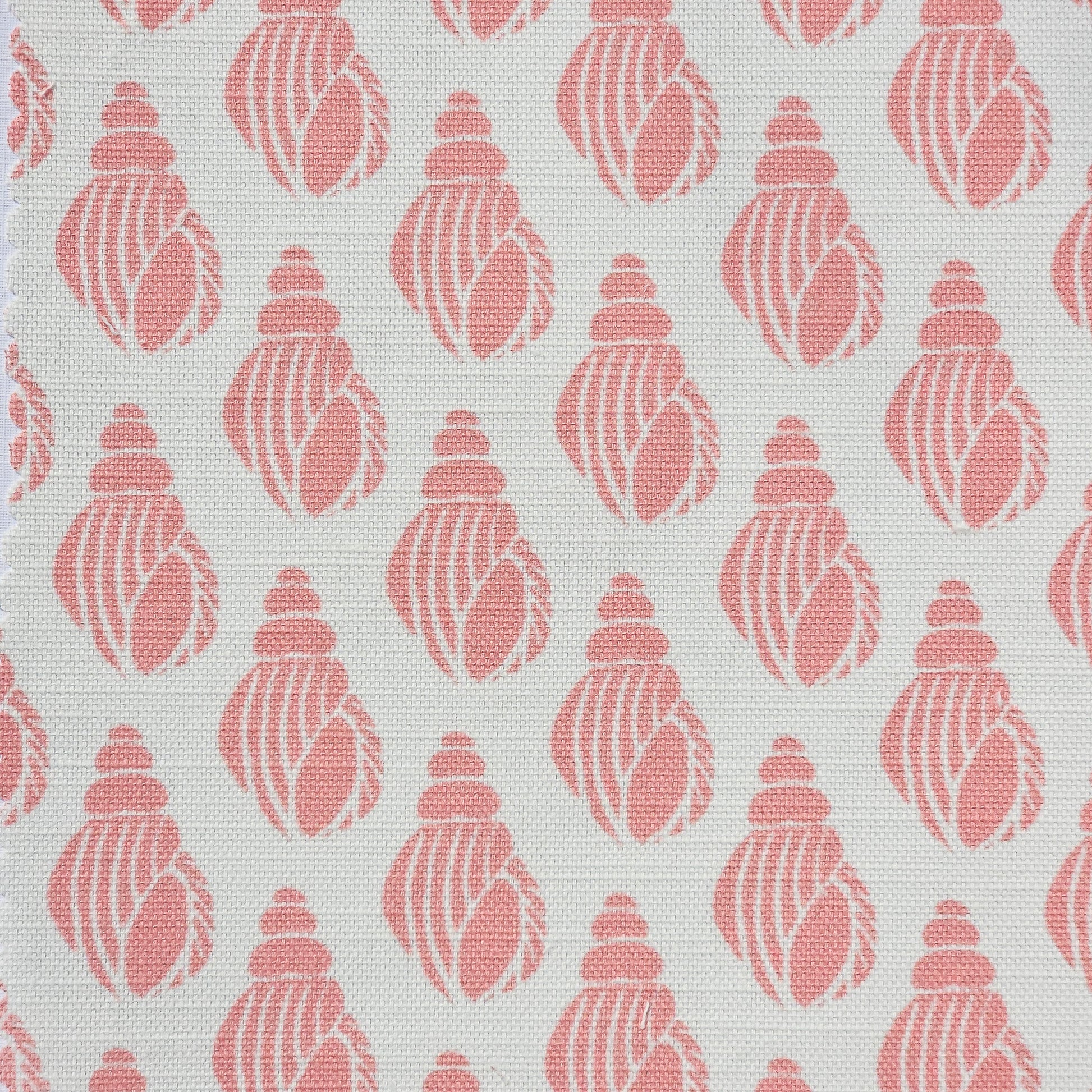 Shell lino print design cotton linen fabric featuring shell motifs in soft coral on an off‑white background. ZIA LIVING