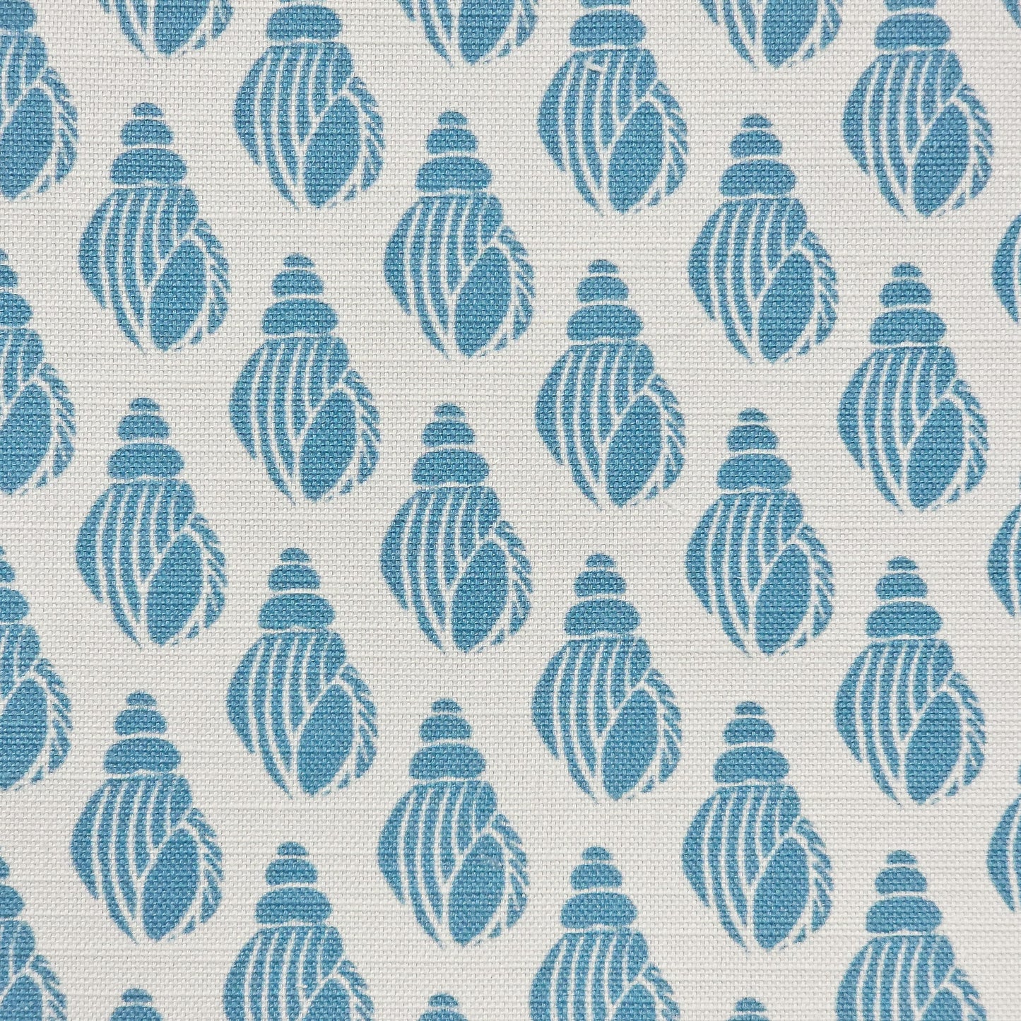 Shell lino print design cotton linen fabric featuring shell motifs in soft sea blue on an off‑white background. ZIA LIVING