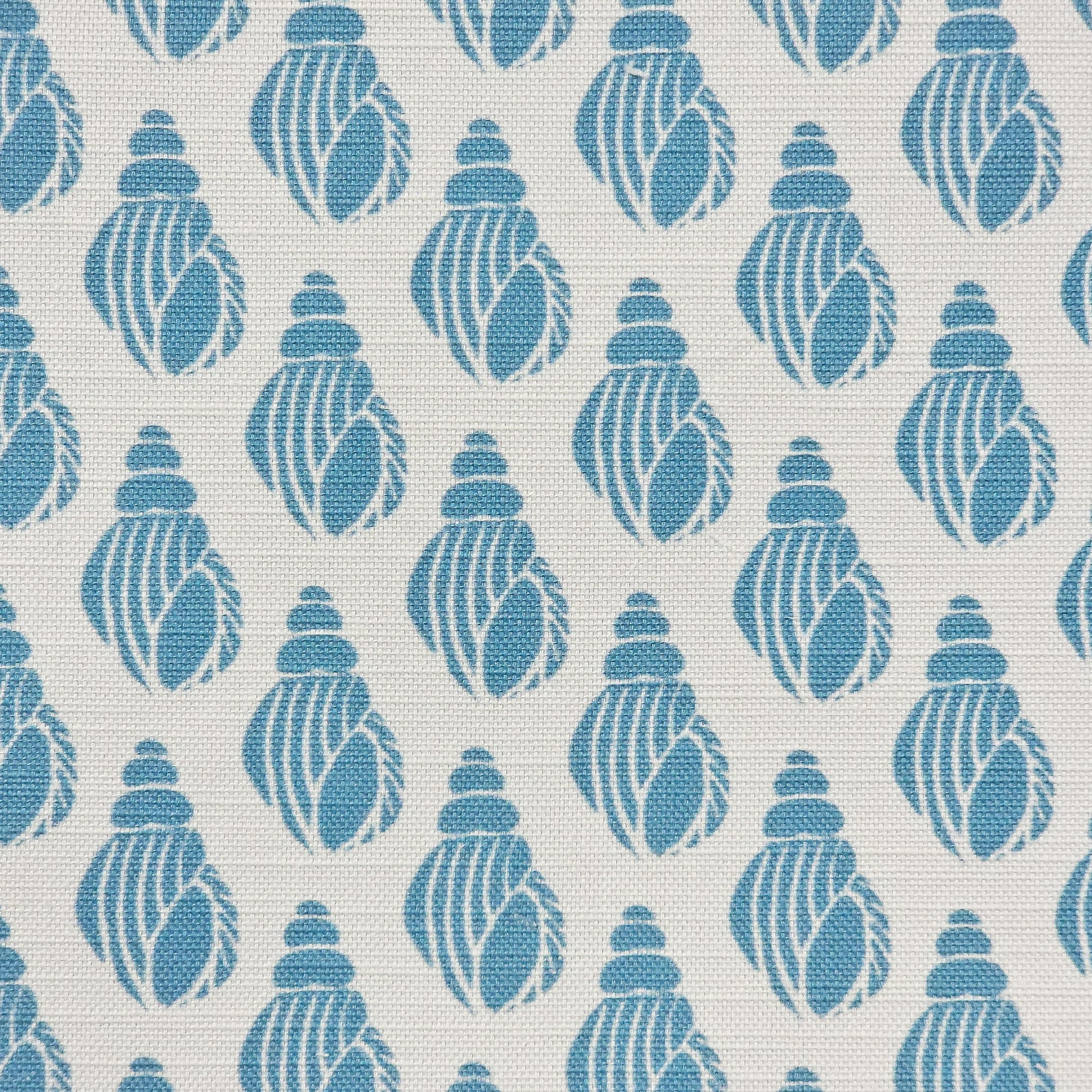 Shell lino print design cotton linen fabric featuring shell motifs in soft sea blue on an off‑white background. ZIA LIVING