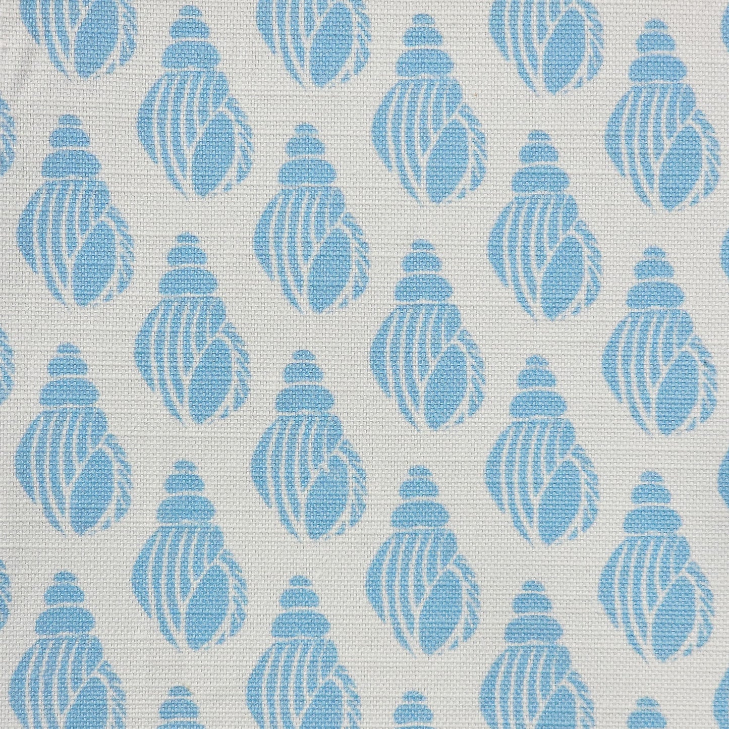 Shell lino print design cotton linen fabric featuring shell motifs in soft sky blue on an off‑white background. ZIA LIVING