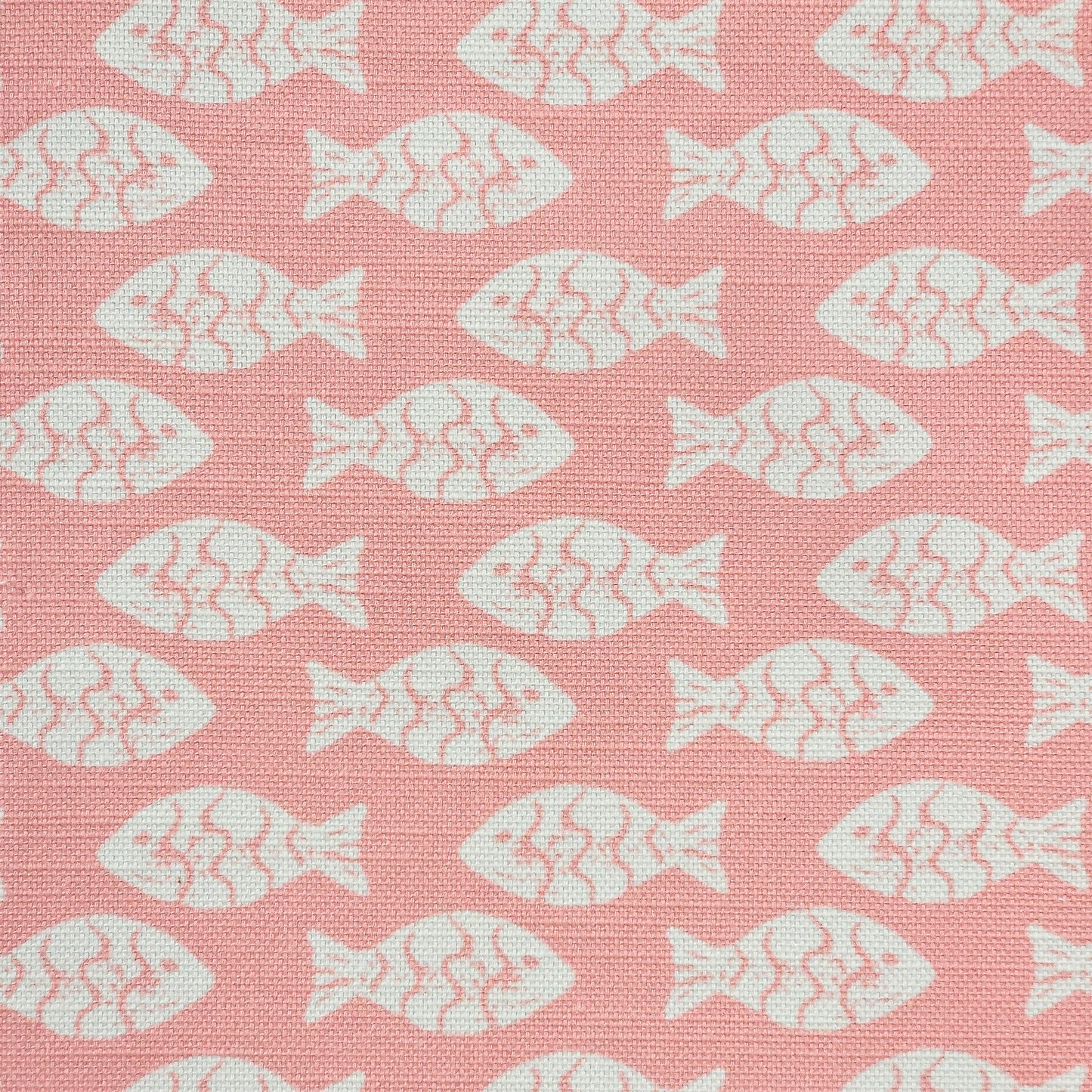 Shoal block‑print cotton linen fabric in off white featuring alternating stylised small fish motifs on an coral coloured background. ZIA LIVING.