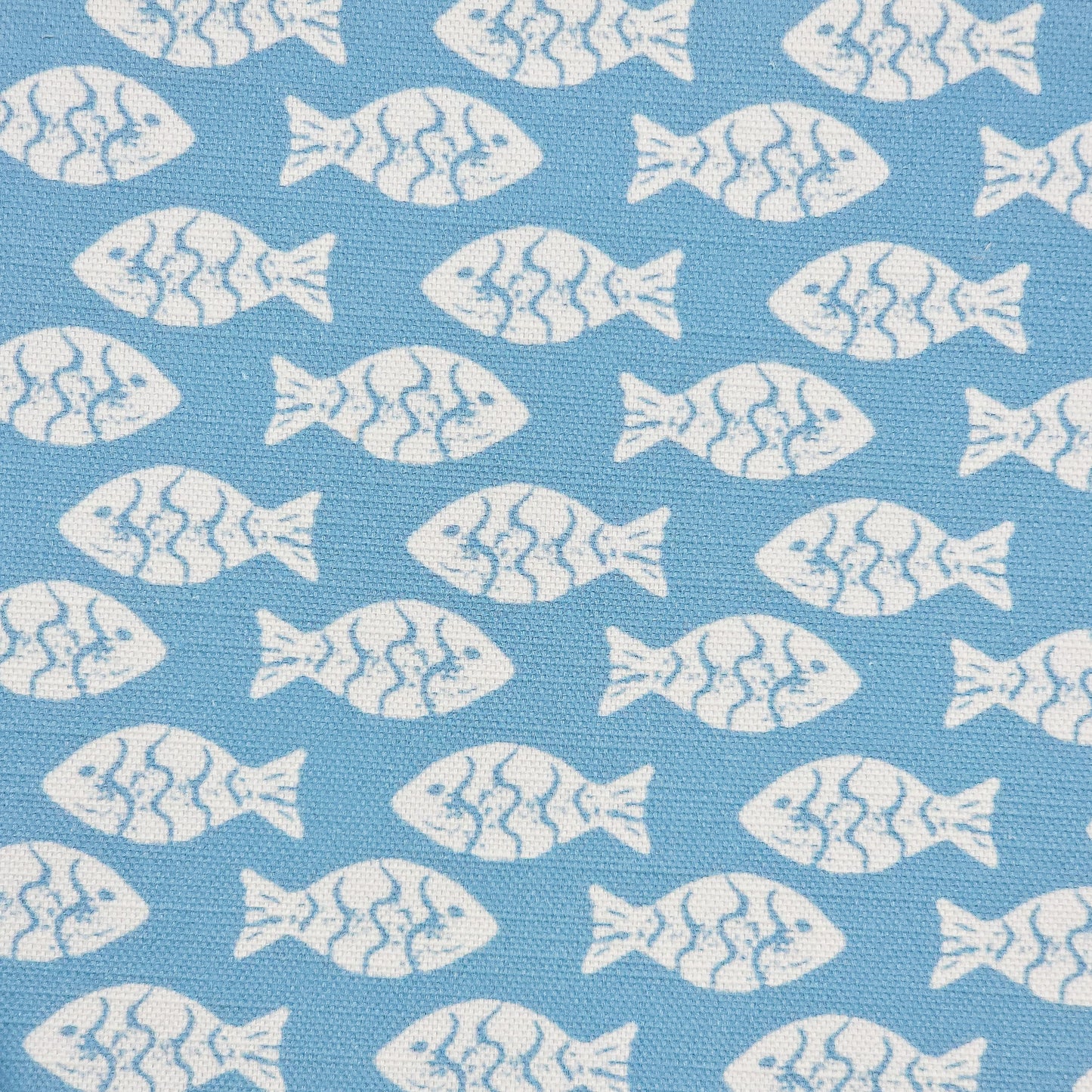Shoal block‑print cotton linen fabric in off white featuring alternating stylised small fish motifs on an sea blue coloured background. ZIA LIVING.