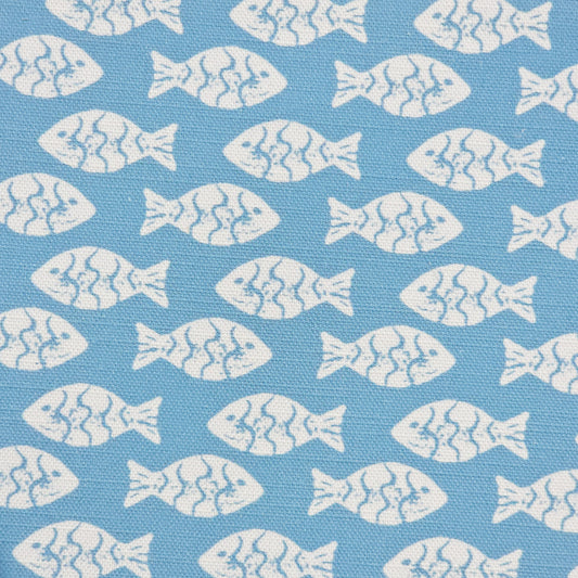 Shoal block‑print cotton linen fabric in off white featuring alternating stylised small fish motifs on an sea blue coloured background. ZIA LIVING.